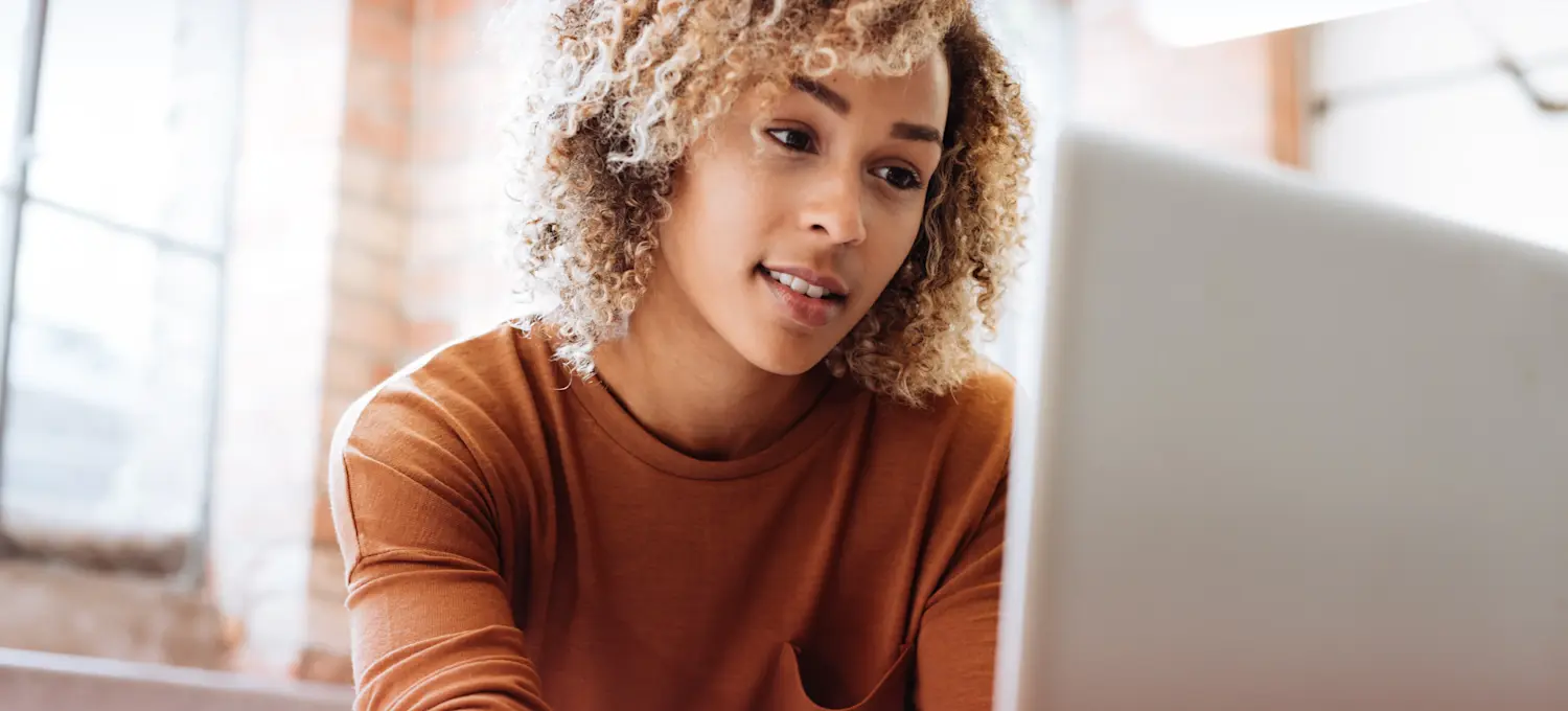 [Featured Image] A person sitting at a computer serves as the superuser for their office.
