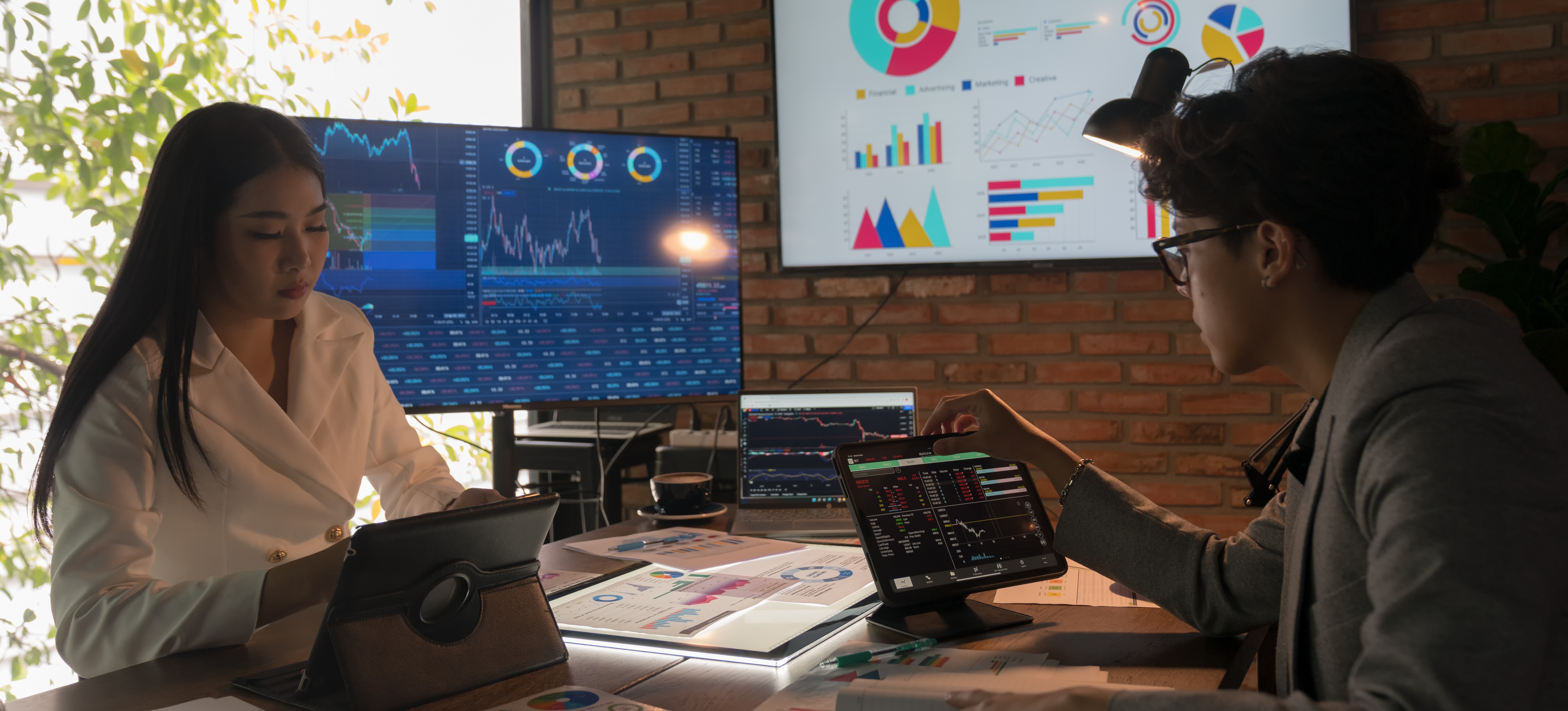 [Featured Image] Professionals in a workplace analyzing code on their computers, with content related to Azure ML and Databricks displayed on their screens.
