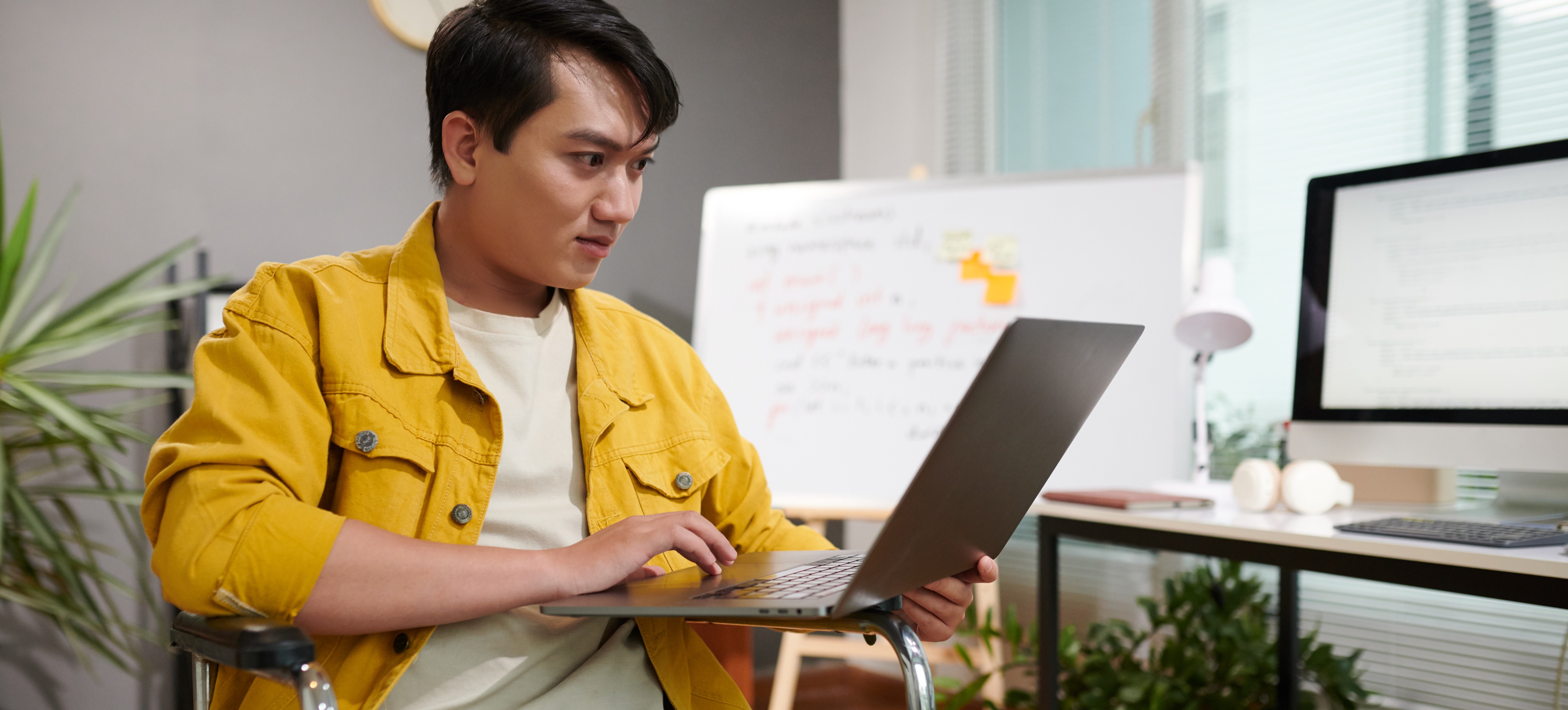 [Featured Image] An AI professional sits in an office space, using chain of thought prompting to help build software solutions for his organization.

