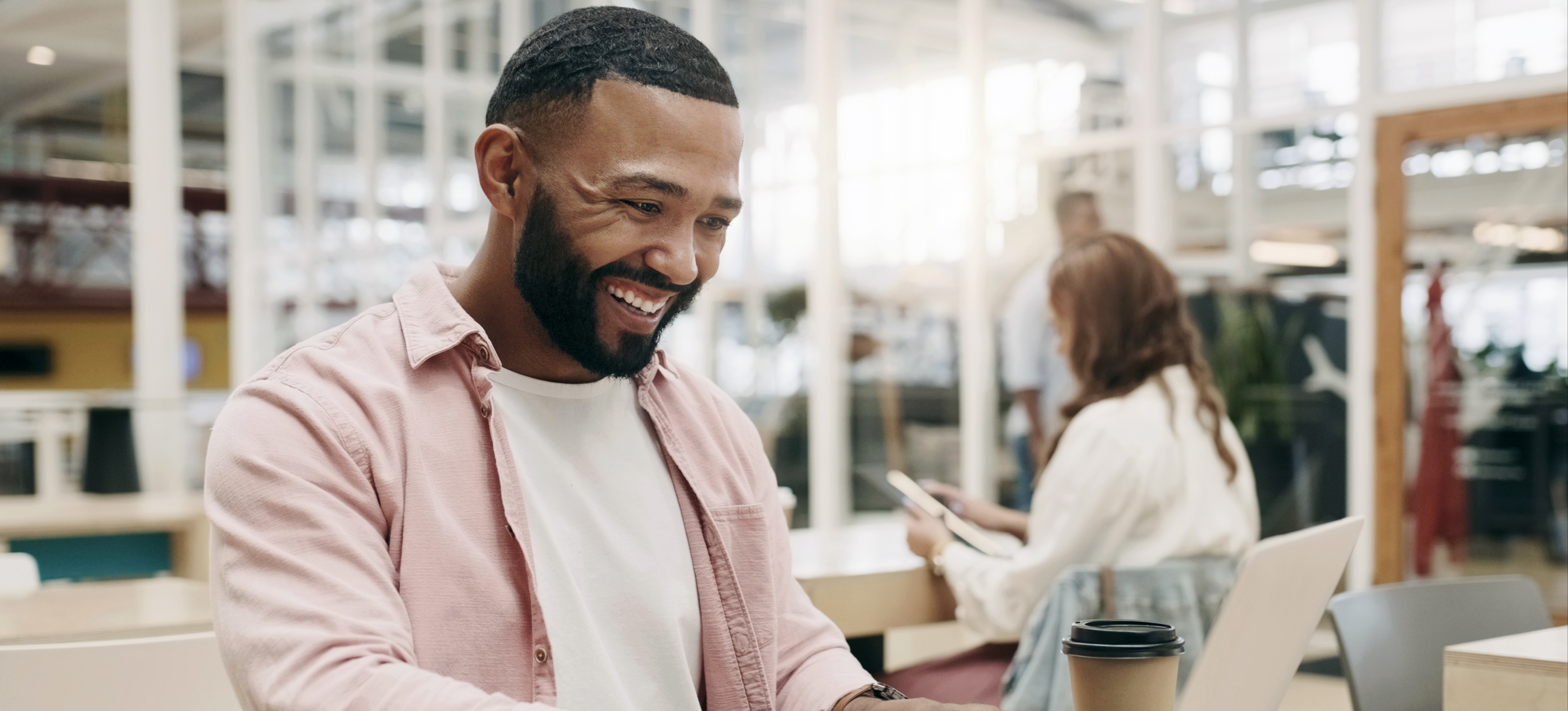 [Feature Image] A human resources professional smiles as they study for their SPHR certification, which is a step toward advancing their career.
