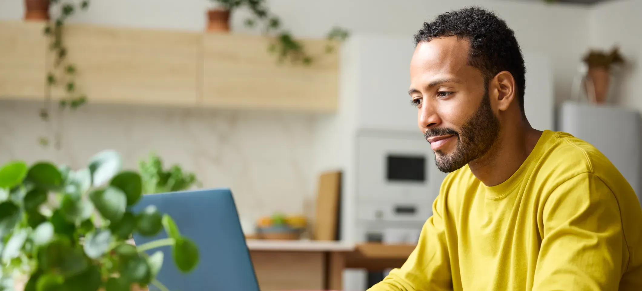 [Featured Image] A young professional researches the best certifications to work from home as they plan their shift from in-office work to a remote position.
