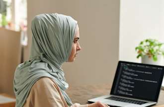 [Featured Image]:  A ServiceNow developer examines code on computer monitors.

