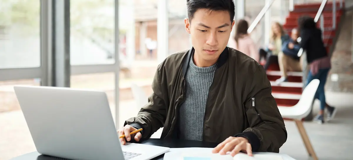 [Featured Image] A learner sees how to humanize AI content while fact-checking AI-generated content on their laptop.
