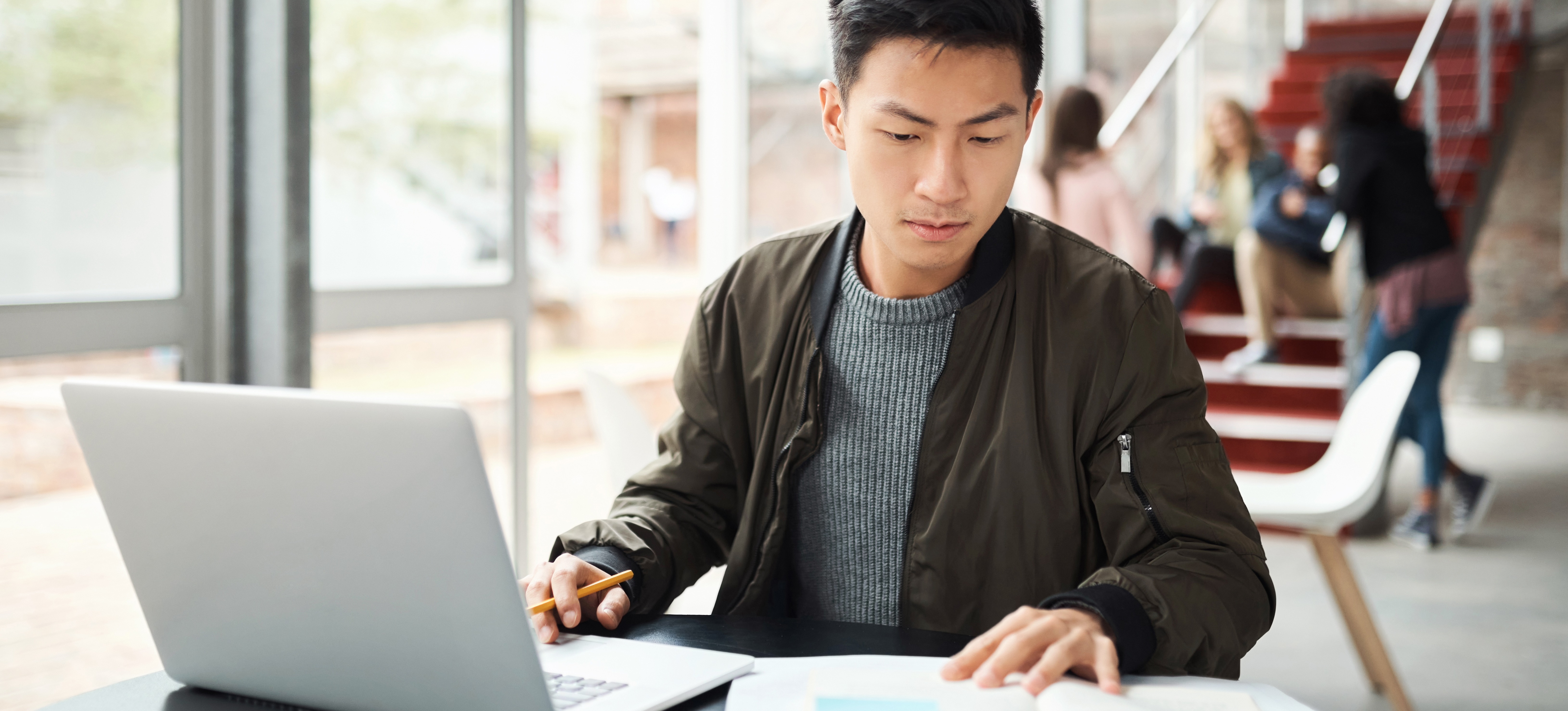 [Featured Image] A learner sees how to humanize AI content while fact-checking AI-generated content on their laptop.
