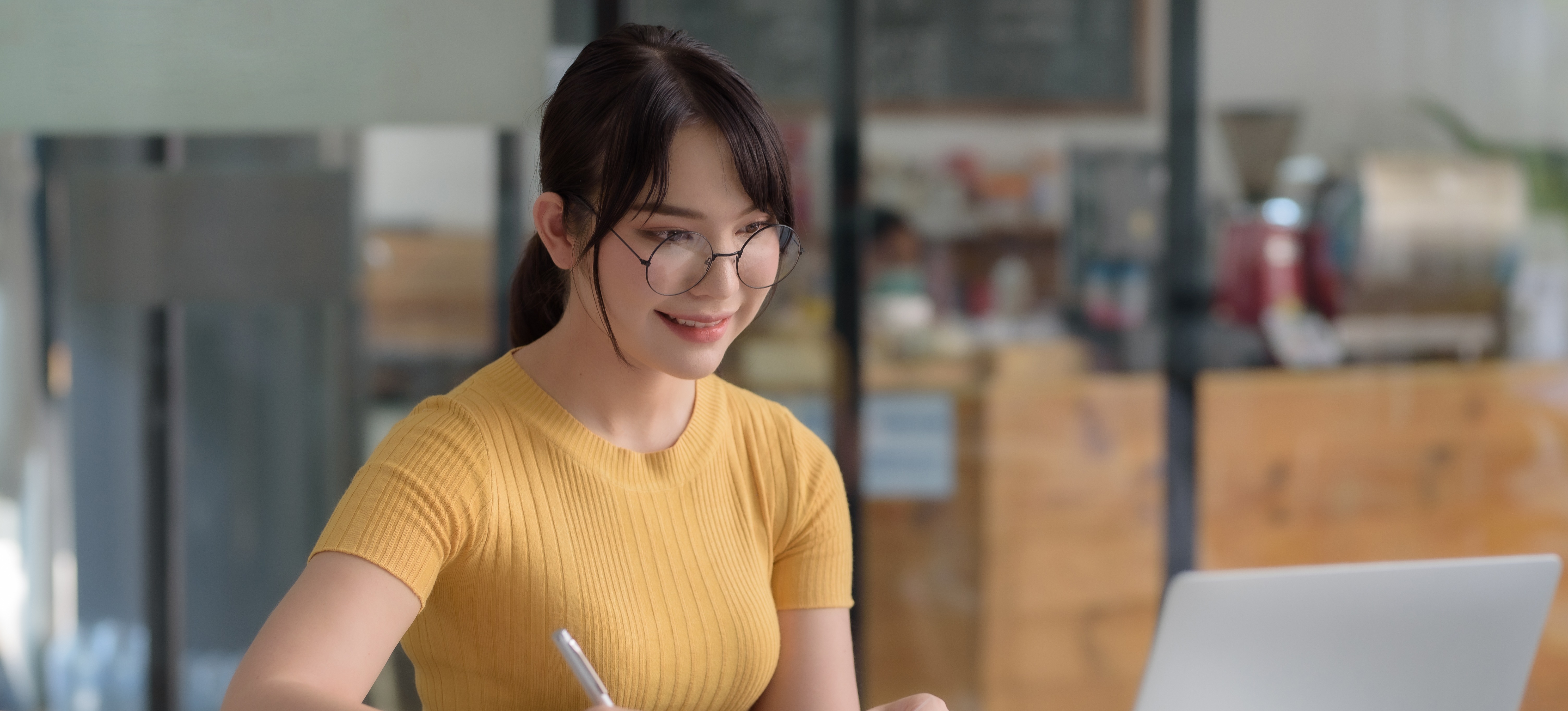 [Featured Image] A young project manager researches the top project management software as they decide which option to implement for their team.
