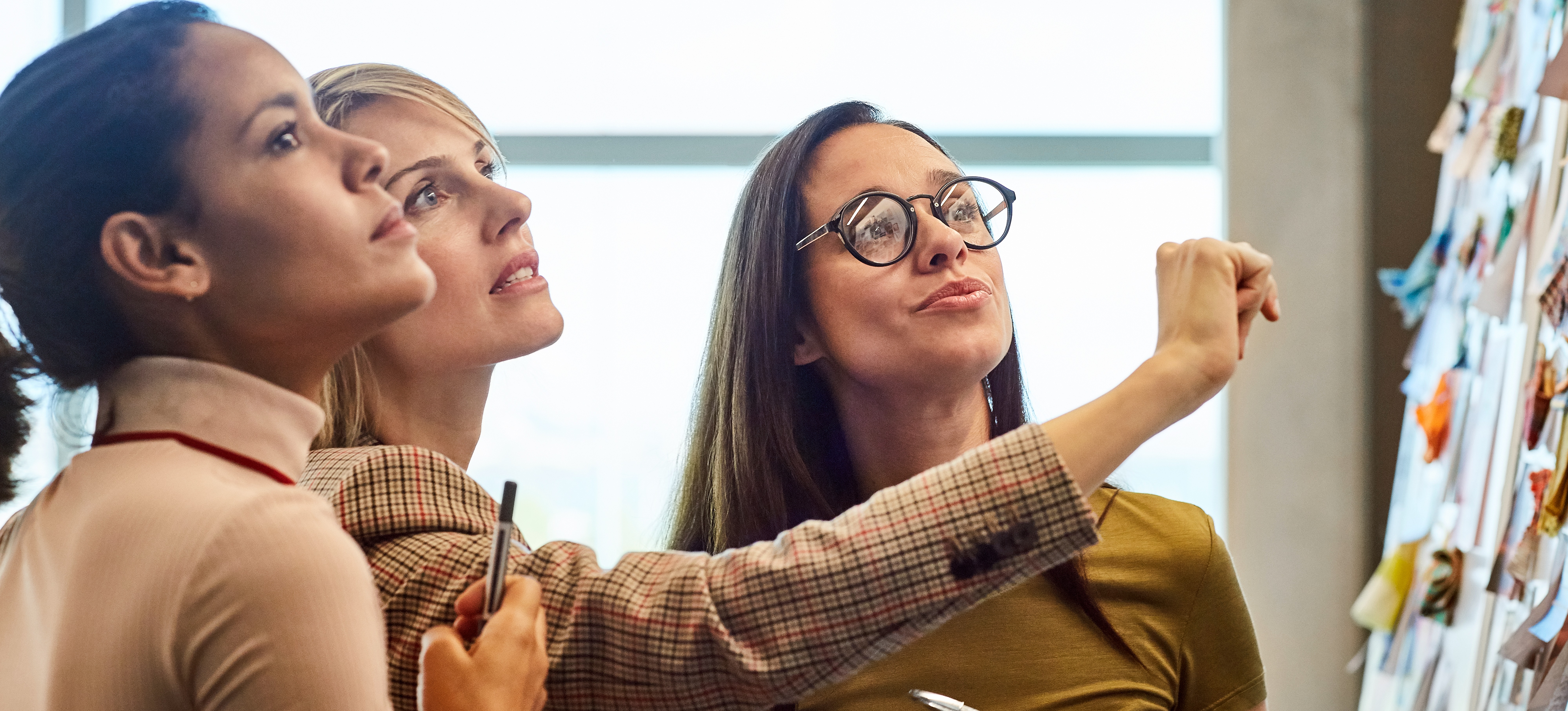 [Feature Image] Three team leaders meet to create a jobs to be done framework to improve business operations and product innovations.

