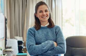 [Featured image] Woman in an office standing in front of a desk