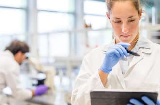 [Featured Image] A biochemist examines a ROC curve on a tablet in the lab. 