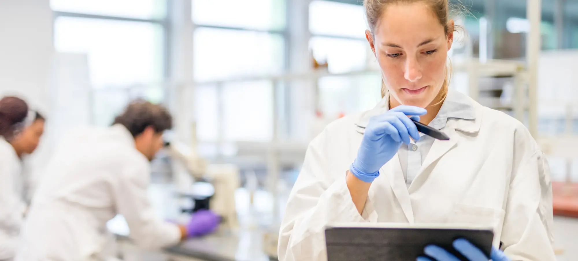 [Featured Image] A biochemist examines a ROC curve on a tablet in the lab. 