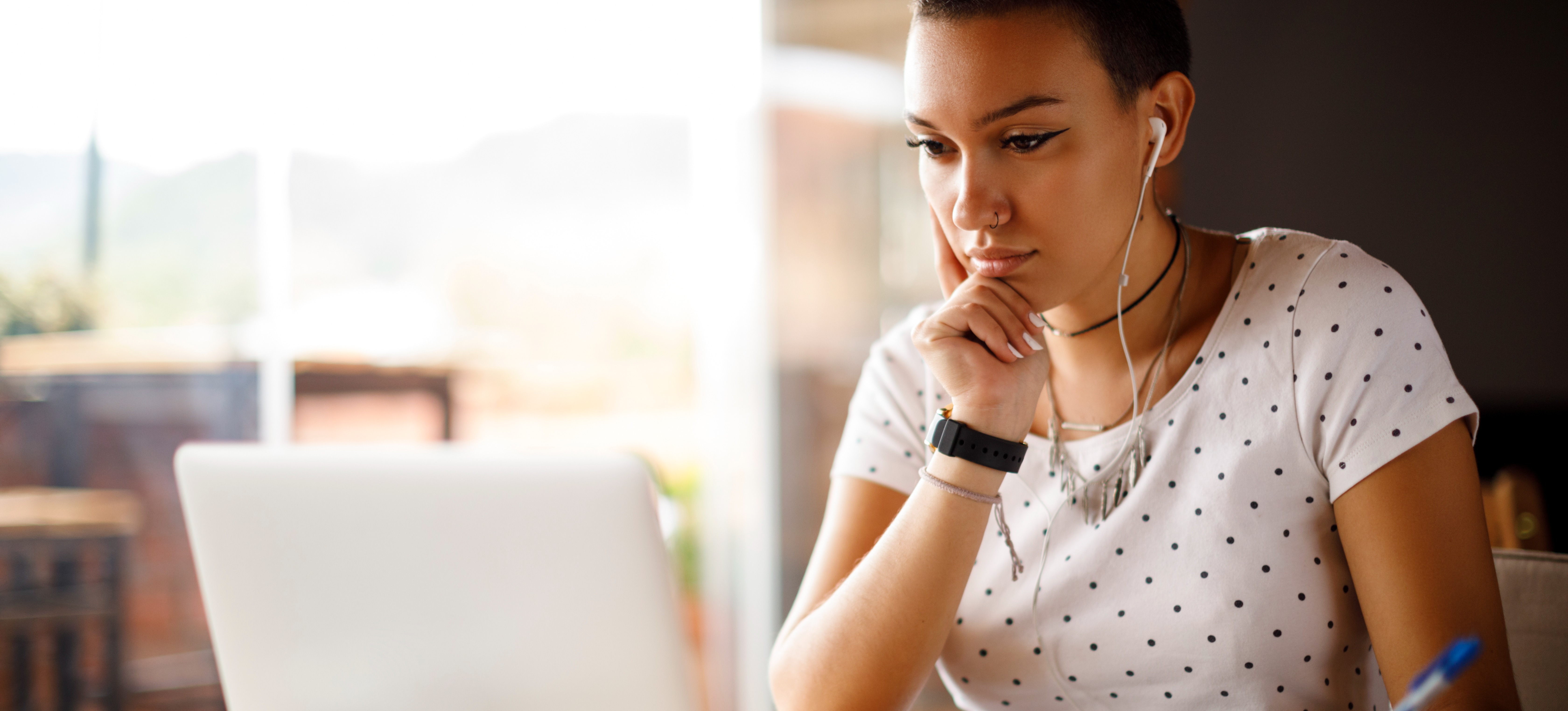 [Featured Image] A job searcher refines their cover letter after getting cover letter tips to help differentiate them from other applicants.
