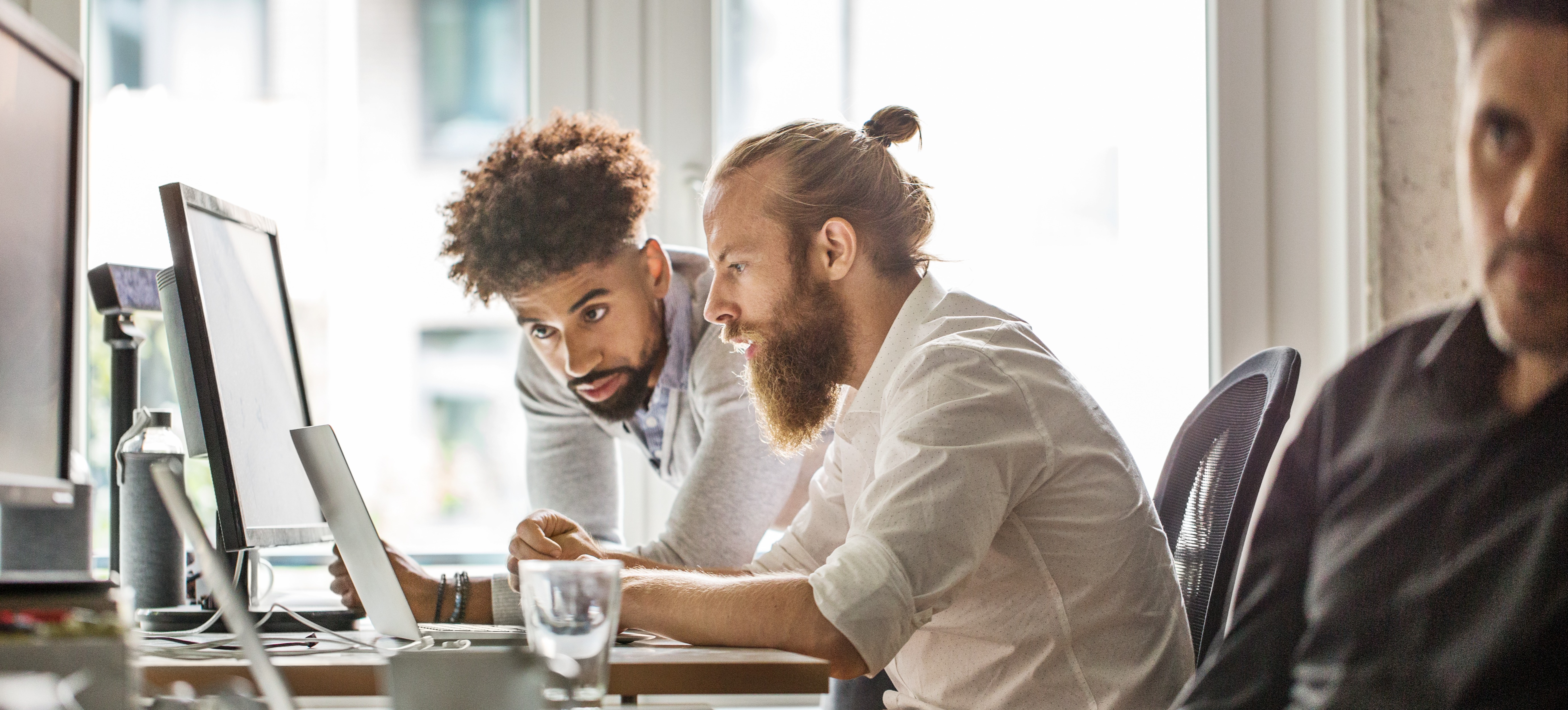 [Feature Image] Two aspiring Linux professionals research Linux salary information as they plan their career paths.
