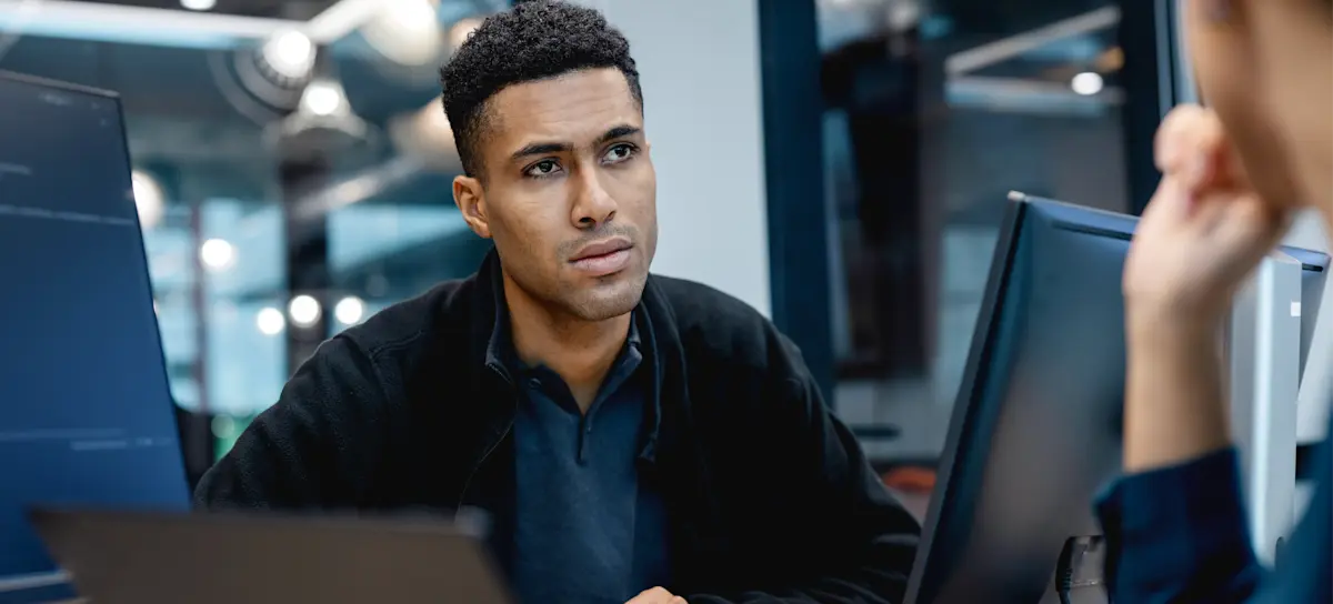 [Featured Image] An aspiring project management professional talks with their mentor about CAPM jobs and their potential career path. 
