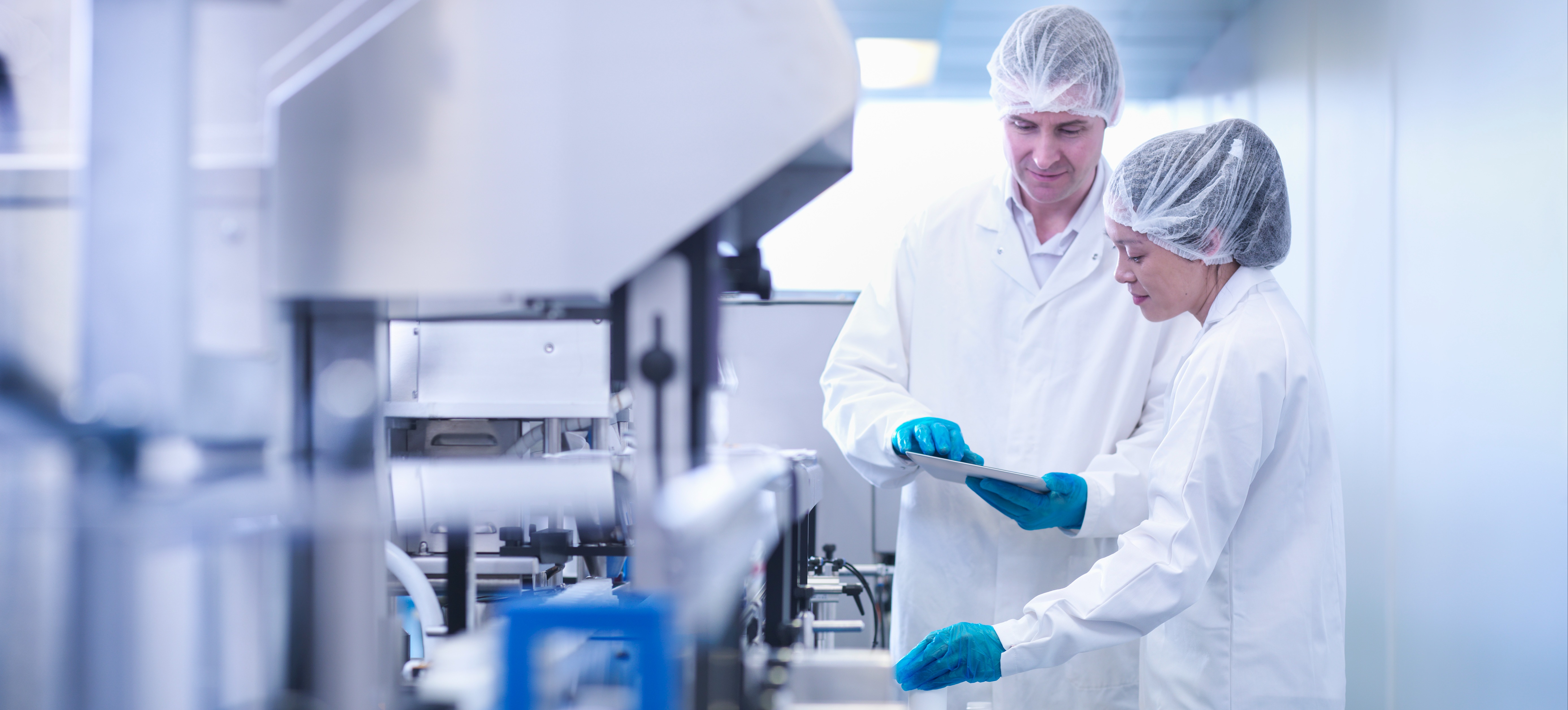 [Featured Image] Two scientists are in a lab testing for user experience research on a product.