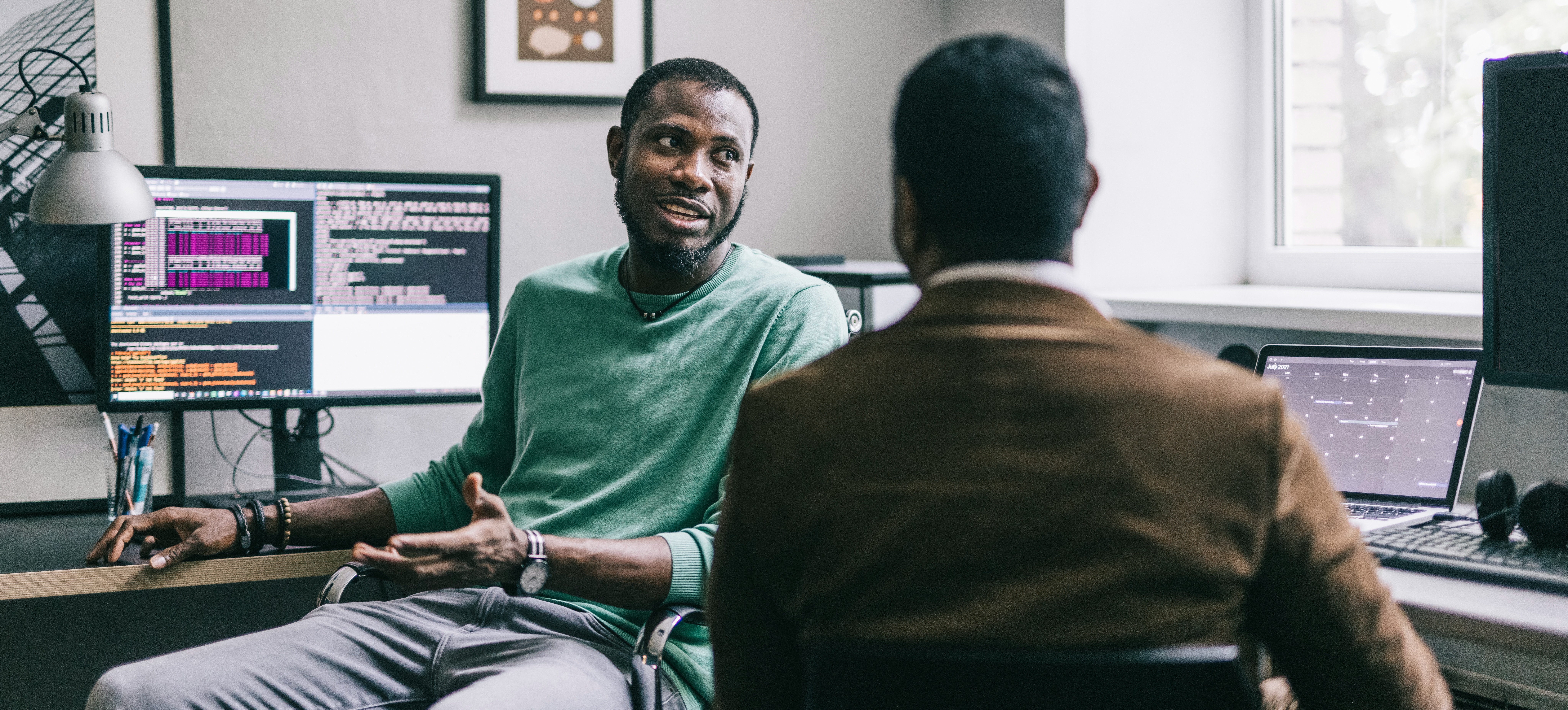 [Featured Image] A software engineer highly skilled in Python is discussing their salary with their manager.