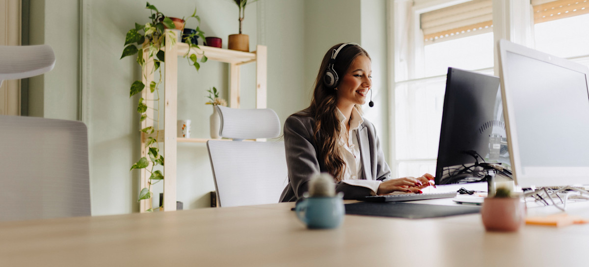 [Feature Image] A learner works in a sunny room on a computer while studying Apache Flink and its capabilities. 
