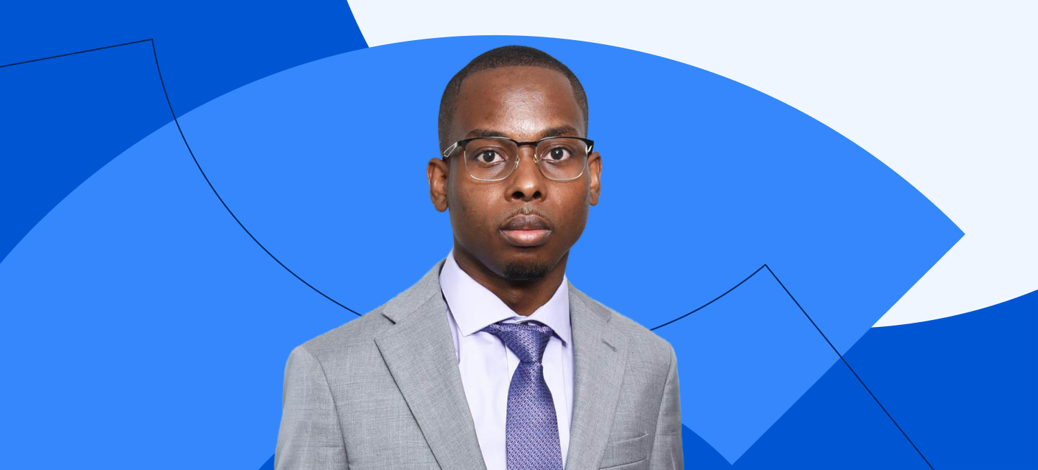 [Featured image] Coursera learner Donald Collins poses in a gray suit with a purple tie.