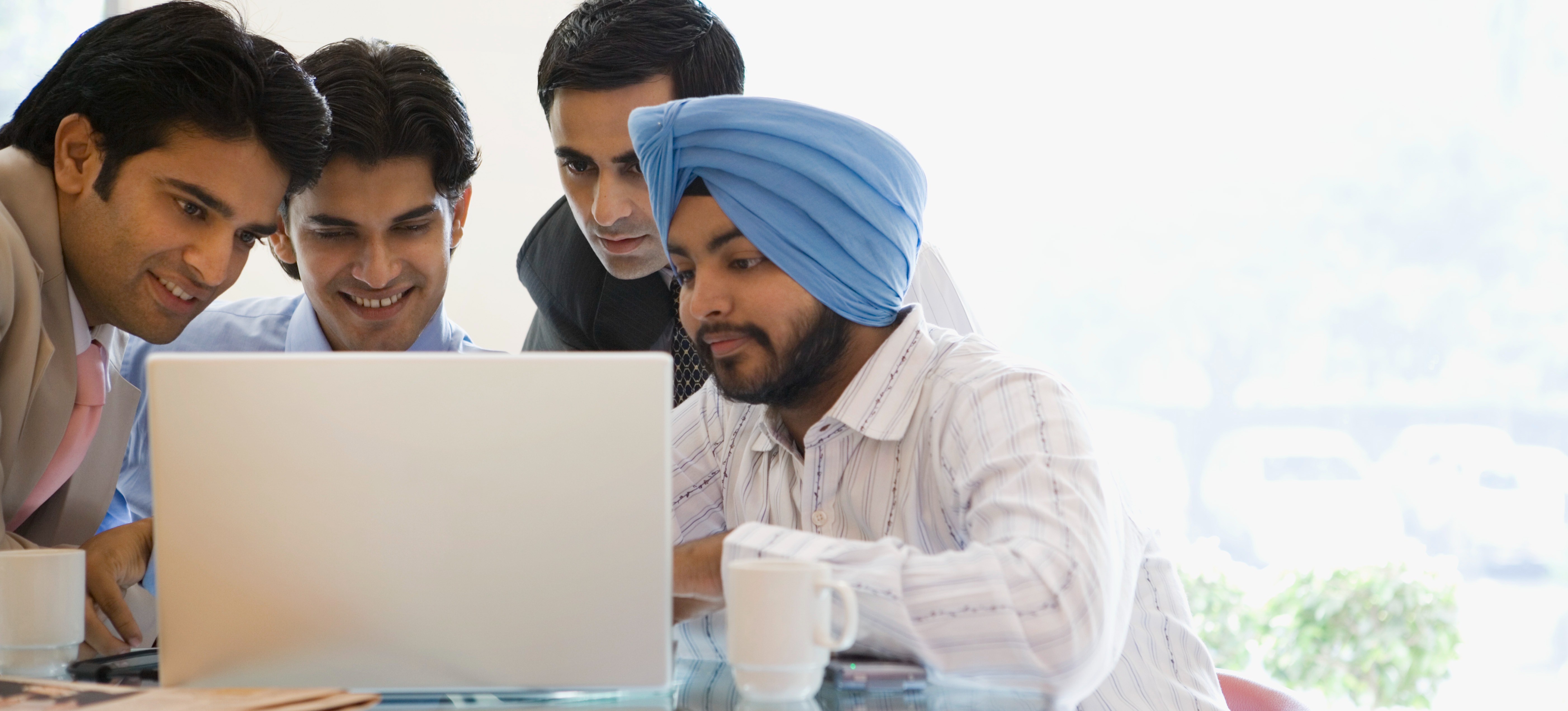 [Featured Image] A group of learners research cybersecurity career paths as they decide on their university course. 
