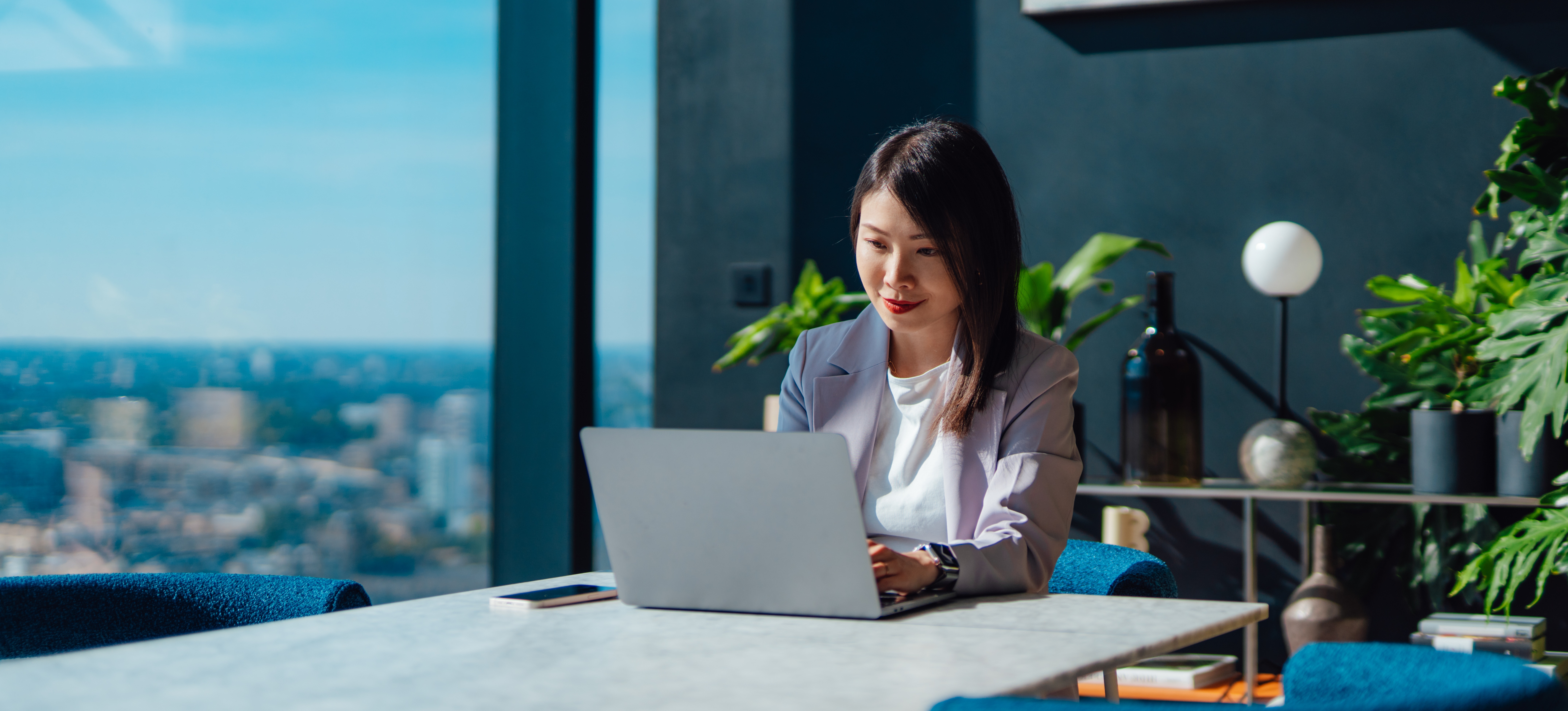[Feature Image] A no-code developer works at their desk in a private business office, quickly creating an application to solve a specific business need. 
