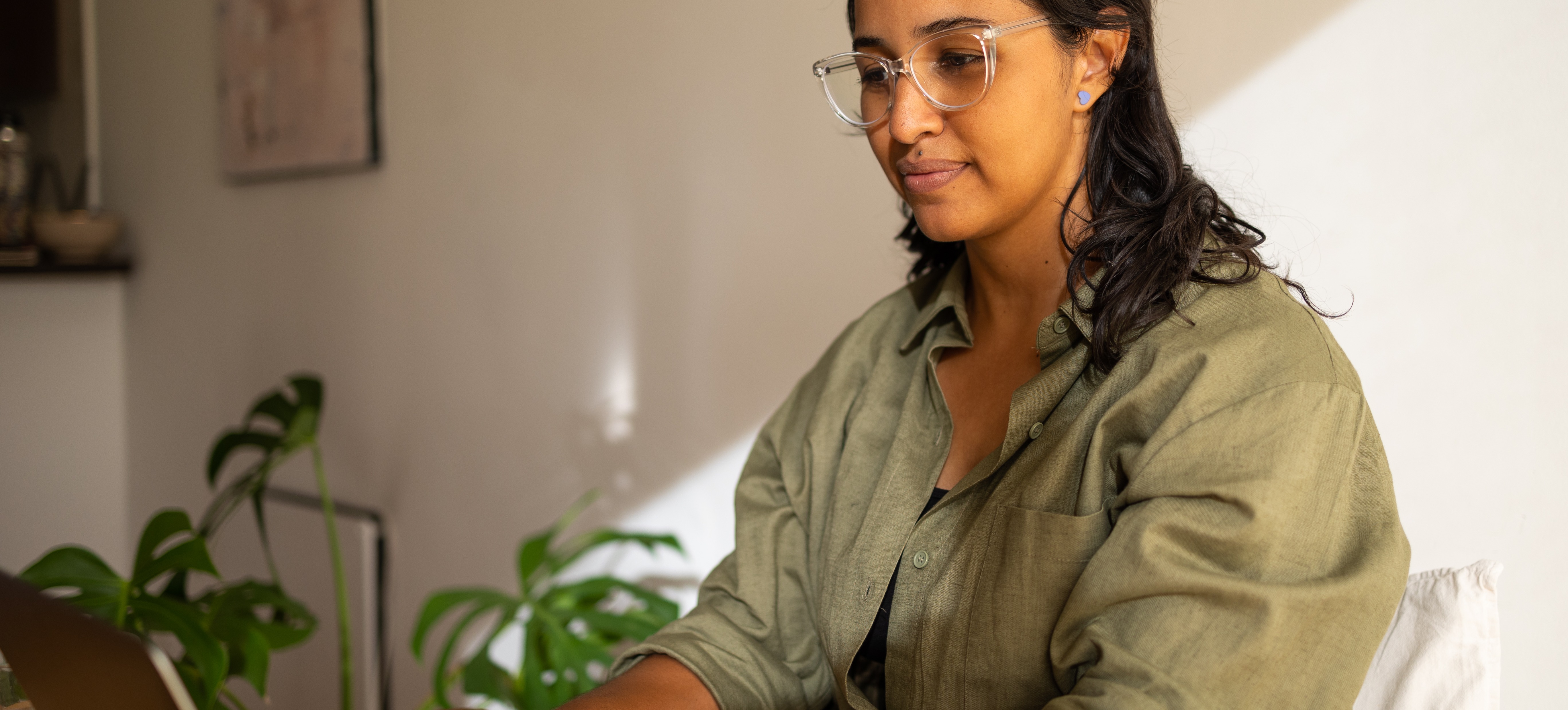 [Featured Image] A person uses their laptop at home to take the exam to earn the IIBA-AAC certification.