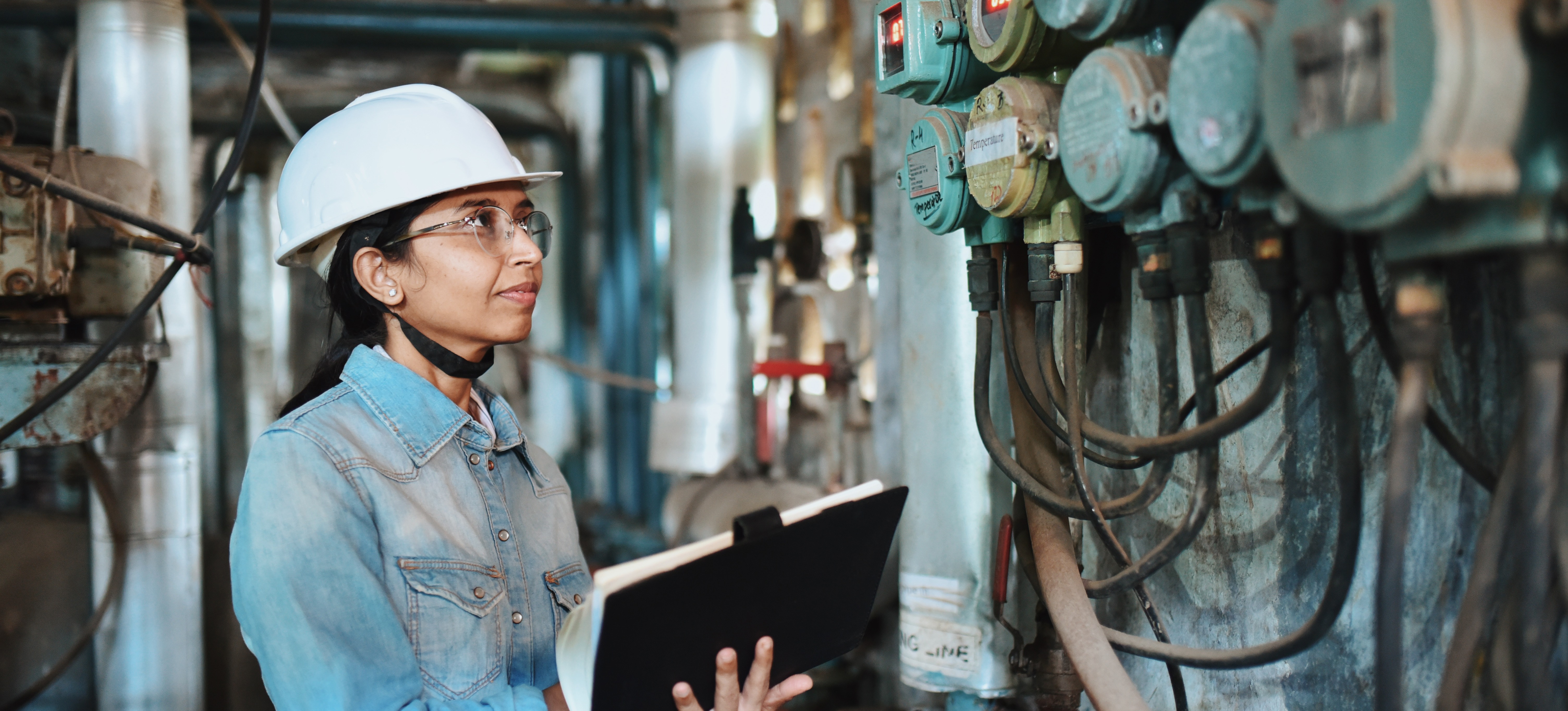 [Featured Image]: An engineer inspects equipment, demonstrating one possible career path for someone who chooses to earn one of the many types of engineering degrees.