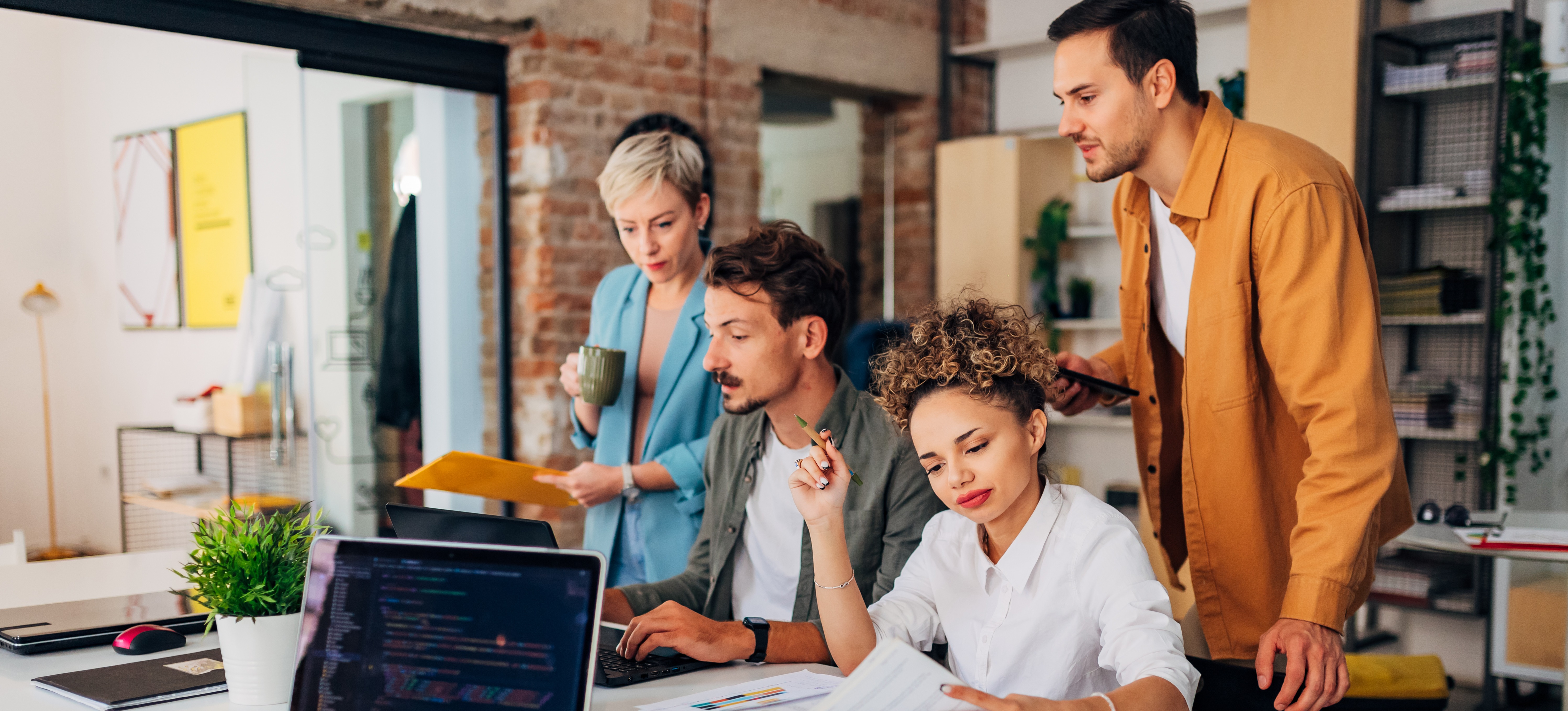 [Featured Image] A team in a workspace interacting and discussing concepts related to how long it takes to learn Figma.