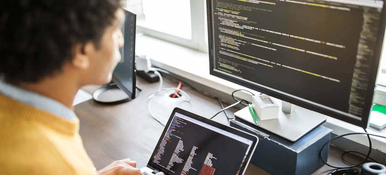 [Featured Image] A person reading data from two separate computer screens earns a big data salary.