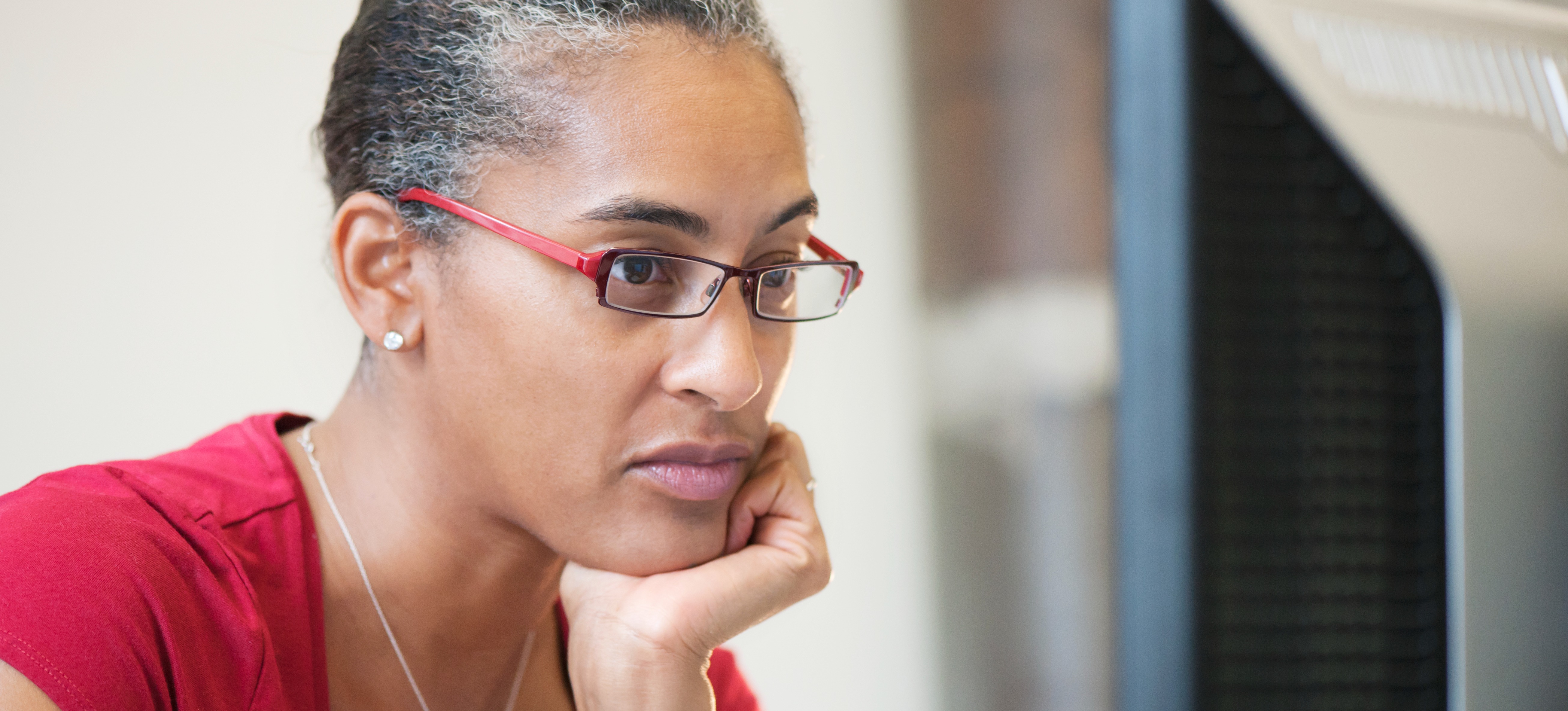 [Featured Image] A person looking at a computer monitor using exFAT to organize their files.