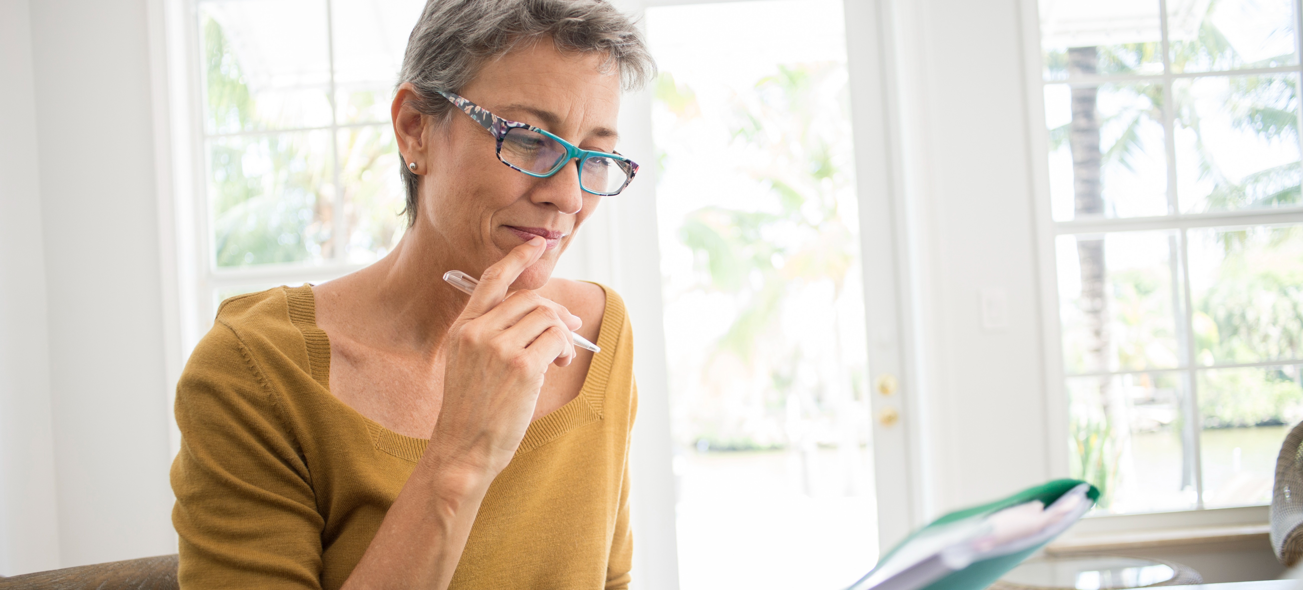[Featured Image] A tax analyst reviews documents as they prepare a report for a client.

