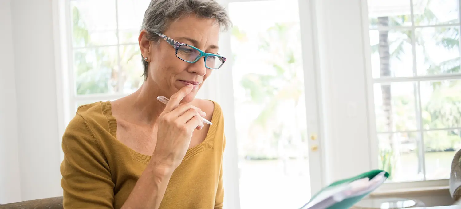 [Featured Image] A tax analyst reviews documents as they prepare a report for a client.
