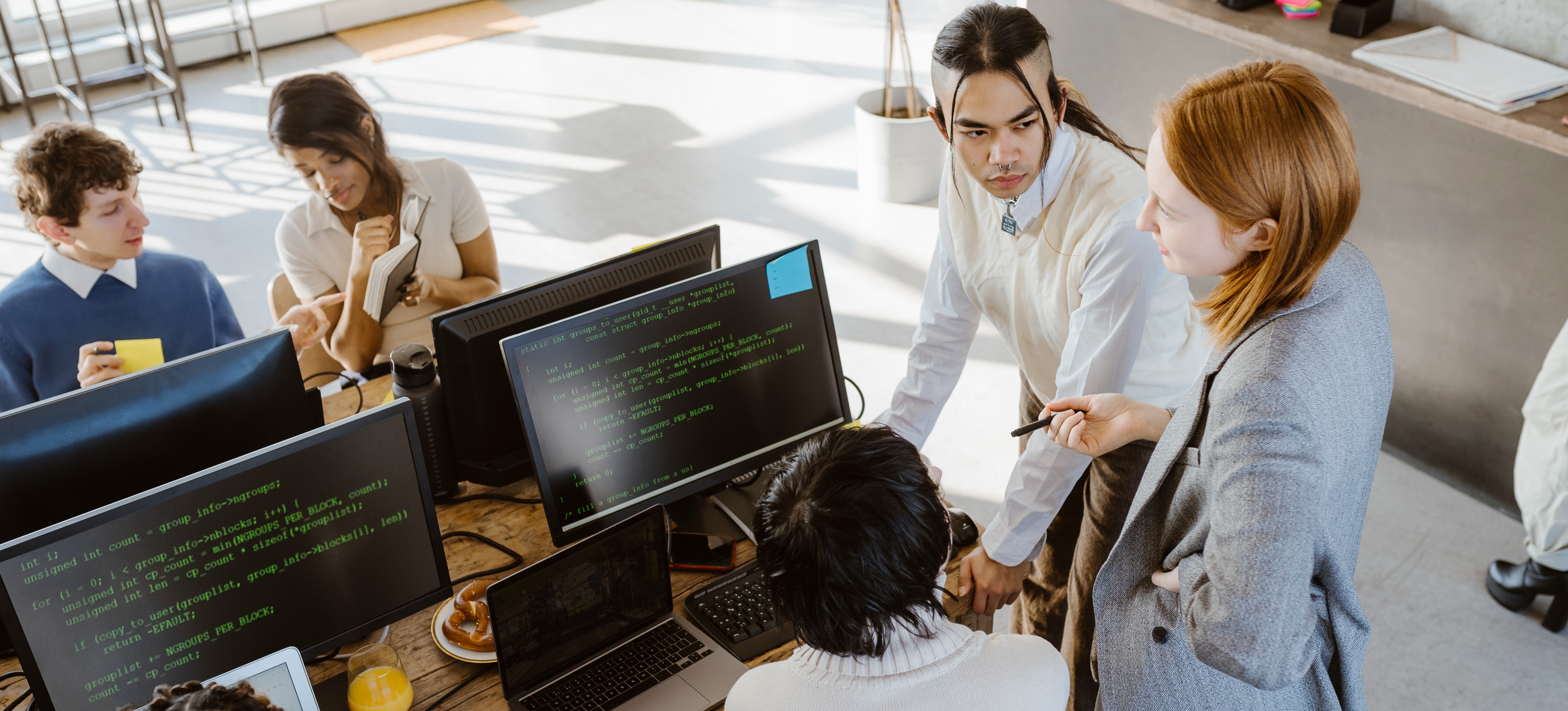[Featured Image] A computer teacher is show students how to code.