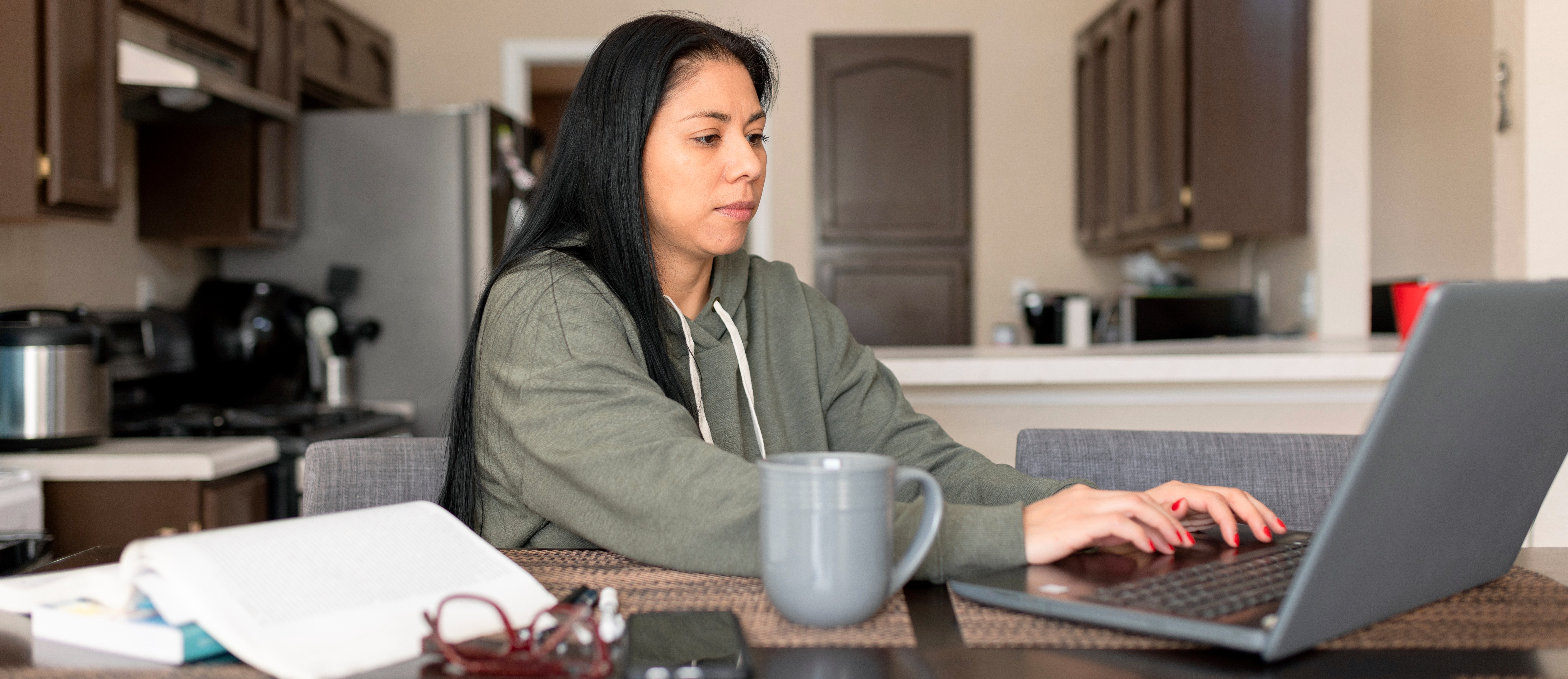 [Feature Image] A prospective learner researches the best platform to learn Python on their home computer as they plan their career and learning pathway.
