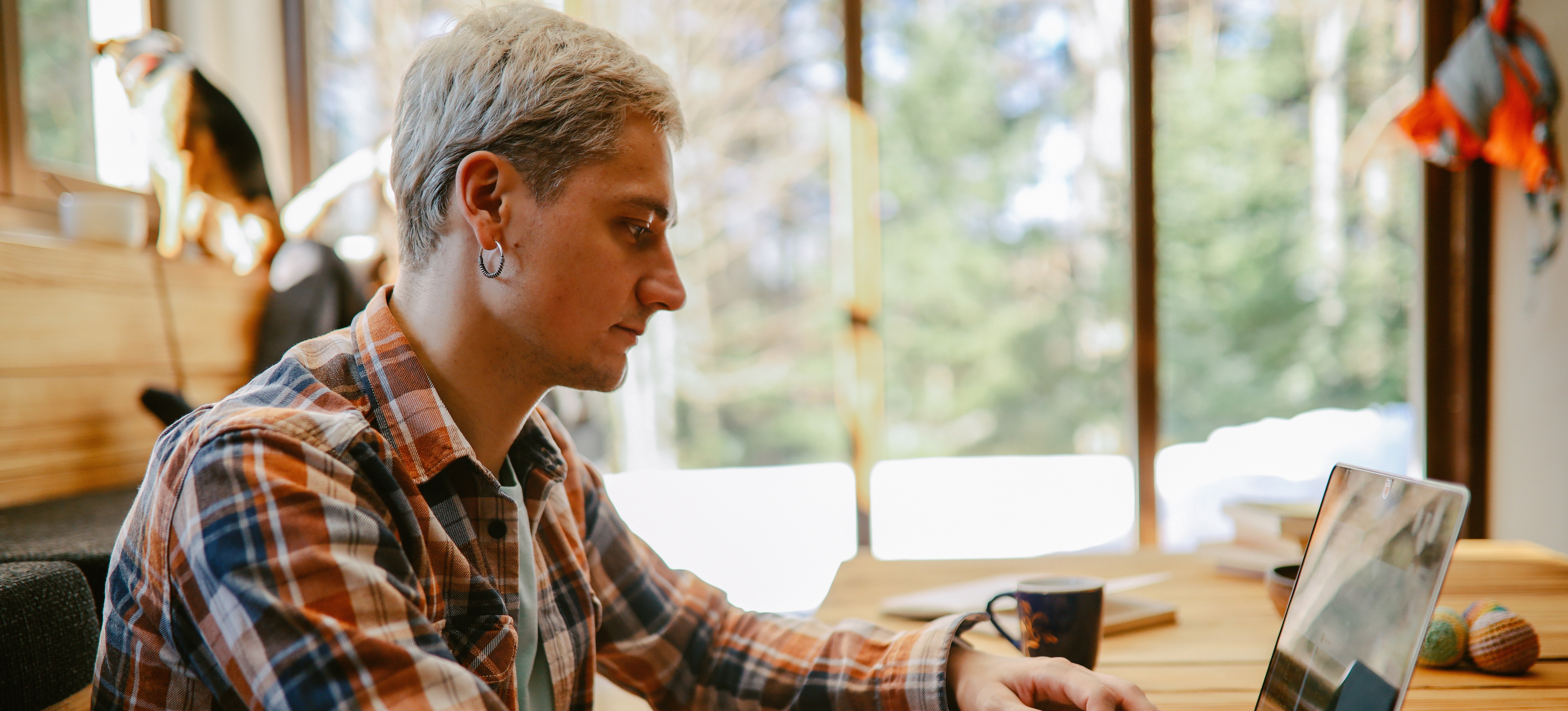 [Featured Image] A full-stack engineer sits at a desk, working on a laptop.
