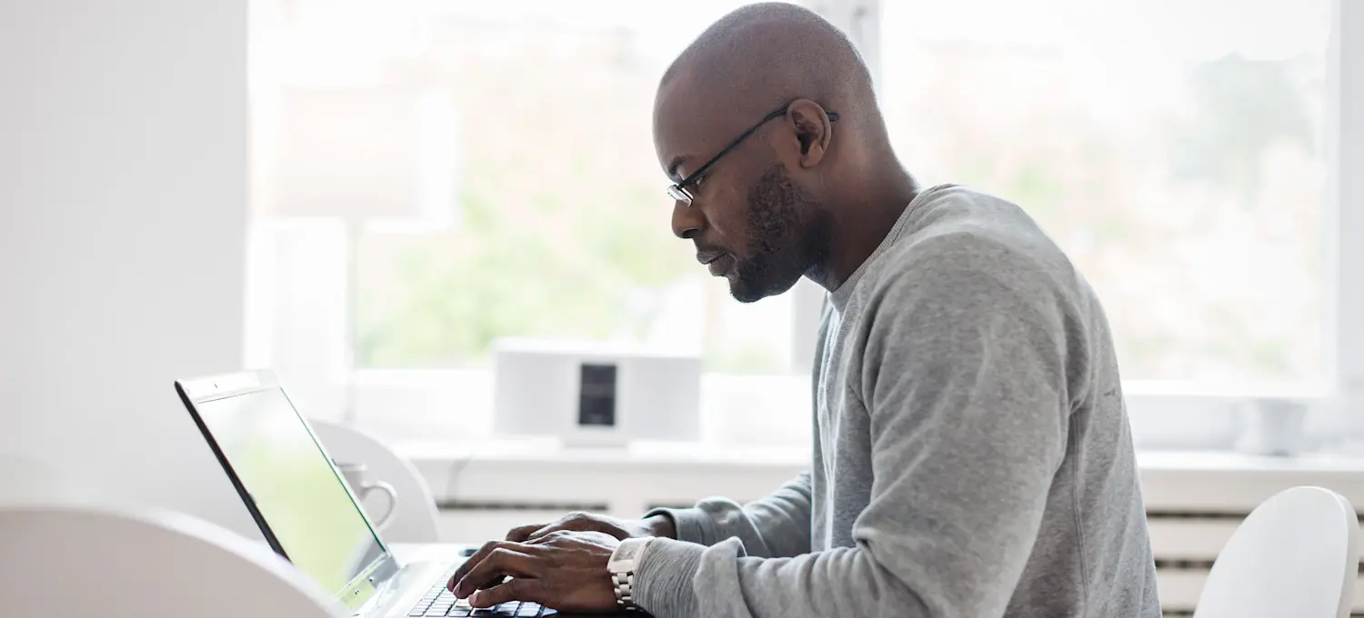 [Featured image] An ETL developer sits at their desk and designs a data storage system. 