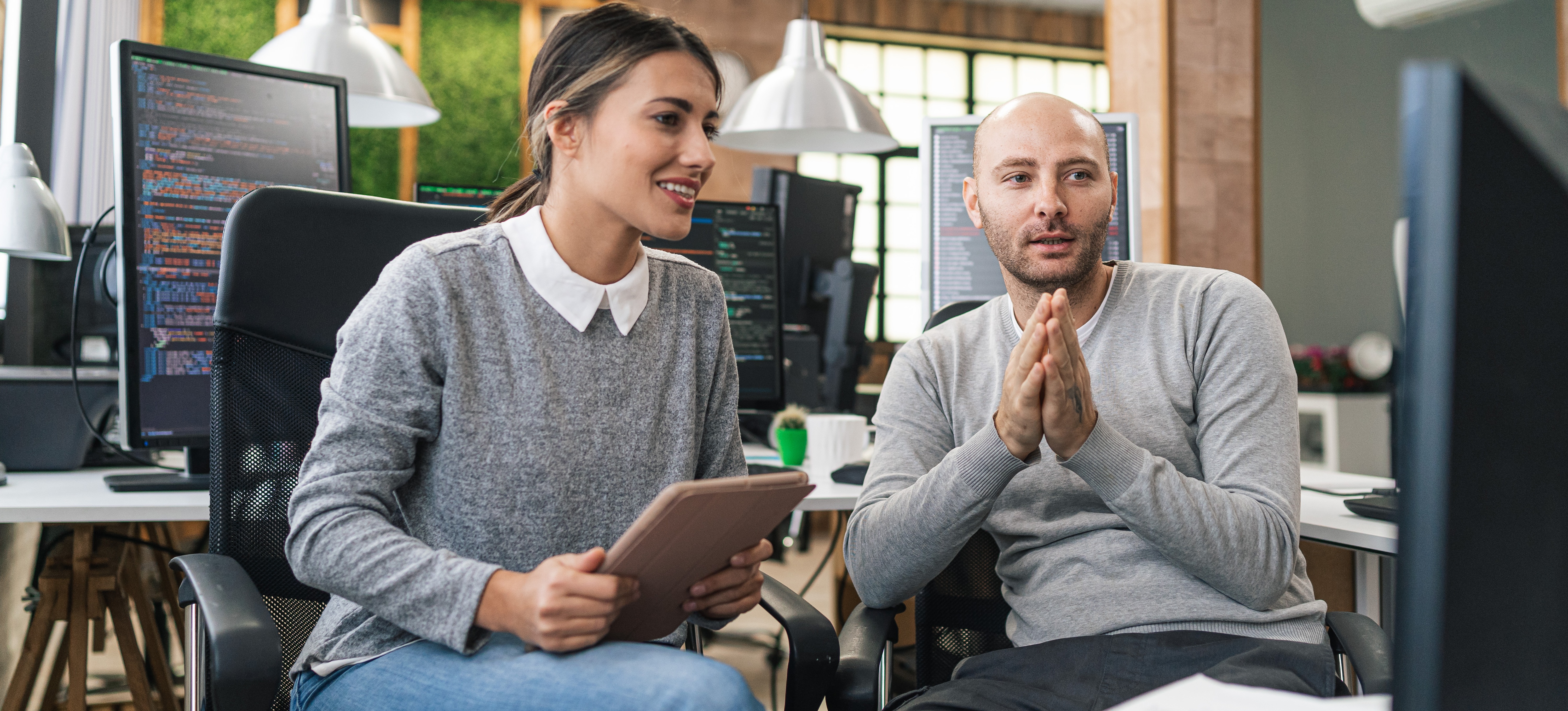 [Featured Image] Two data engineers are using neural networks to recognize patterns and process data.