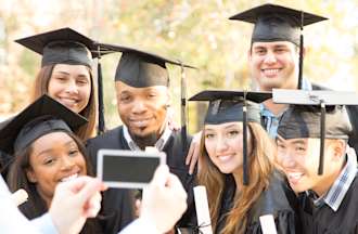 [Featured Image] A group of college students pose for a picture at graduation after earning their bachelor's degrees.