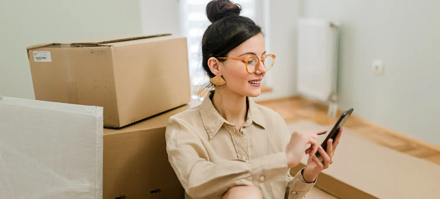 [Featured Image] A person packed to move closer to a job that will help them pay for grad school.
