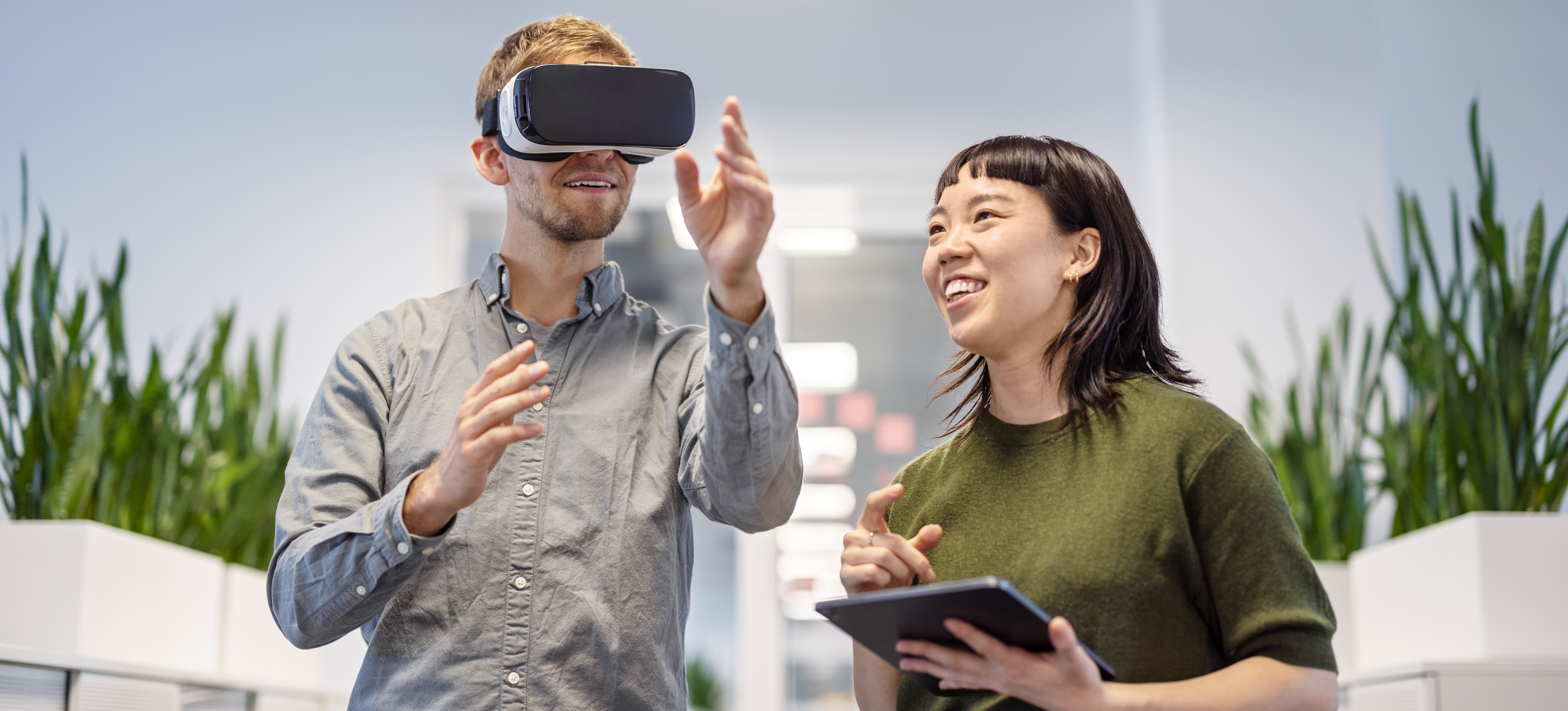 [Featured Image] Two developers discussing augmented reality frameworks