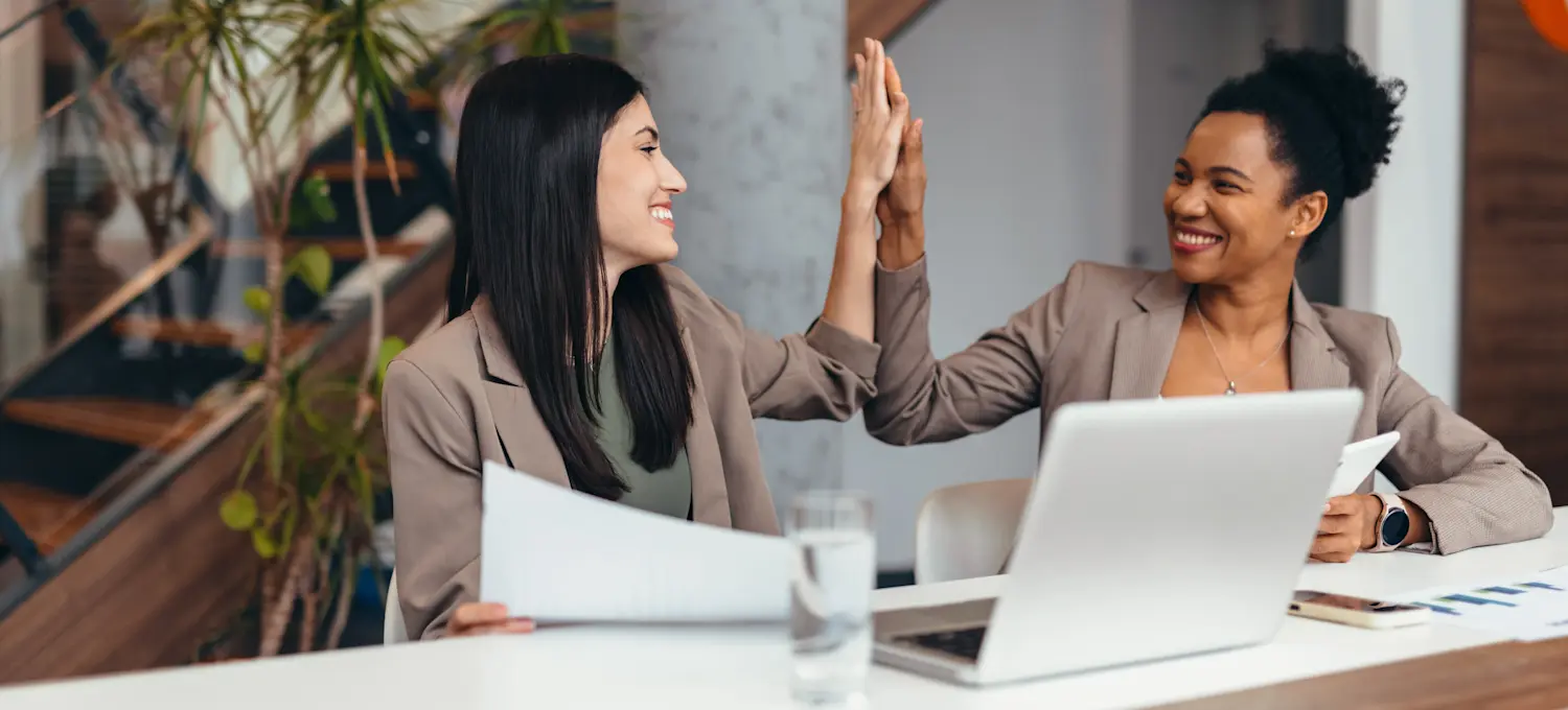 [Featured Image] Professionals in a work environment interacting and discussing Adobe Firefly.

