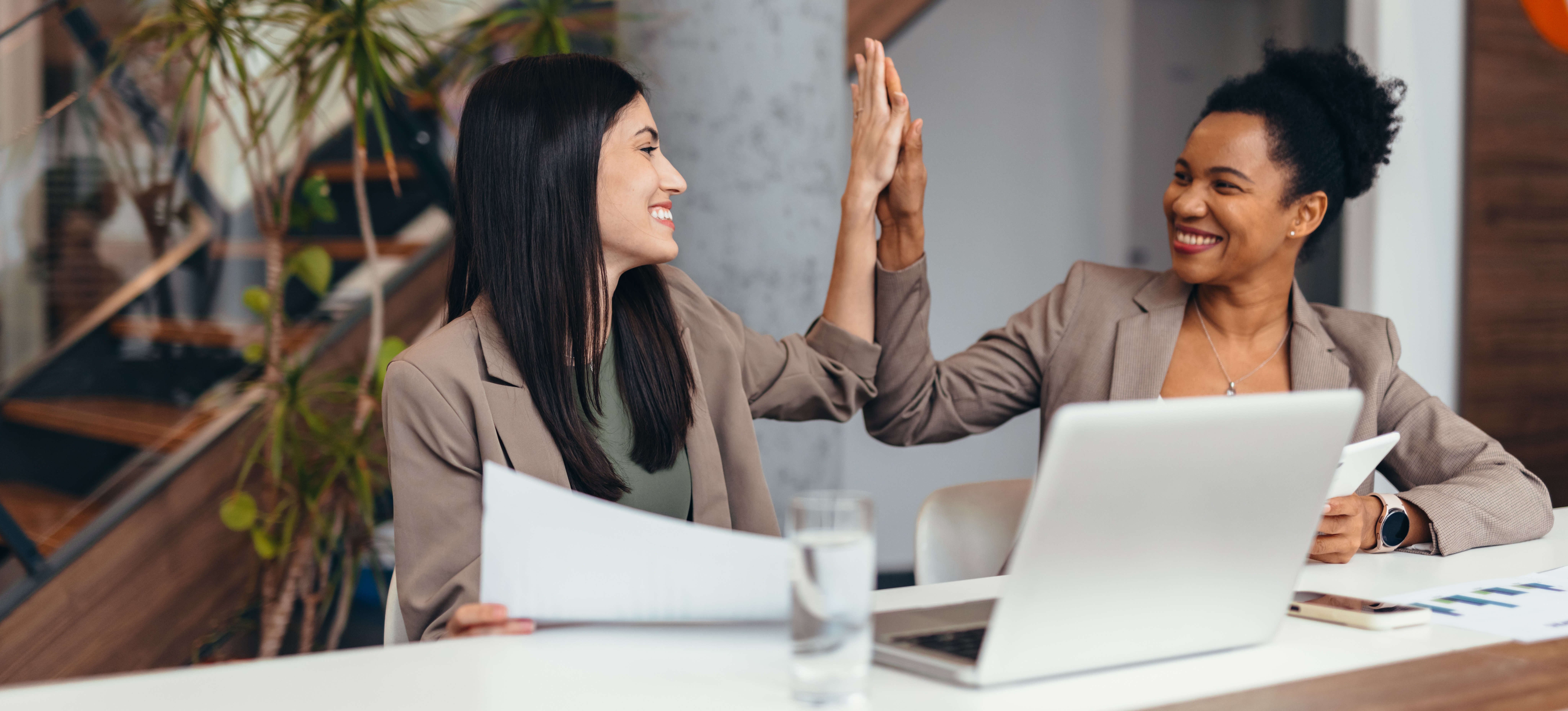 [Featured Image] Professionals in a work environment interacting and discussing Adobe Firefly.
