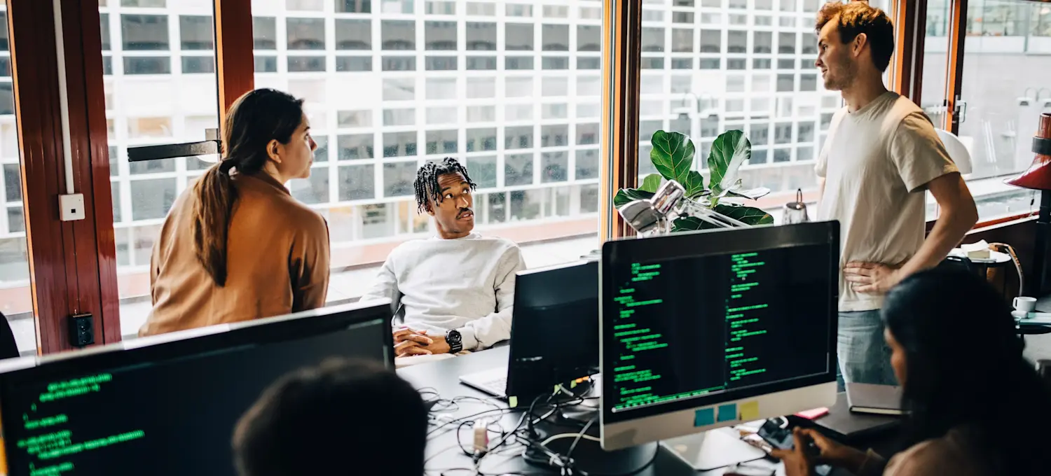 [Featured Image] Three business leaders are meeting in their office, discussing the security of data while cautiously integrating generative AI into the daily tasks.
