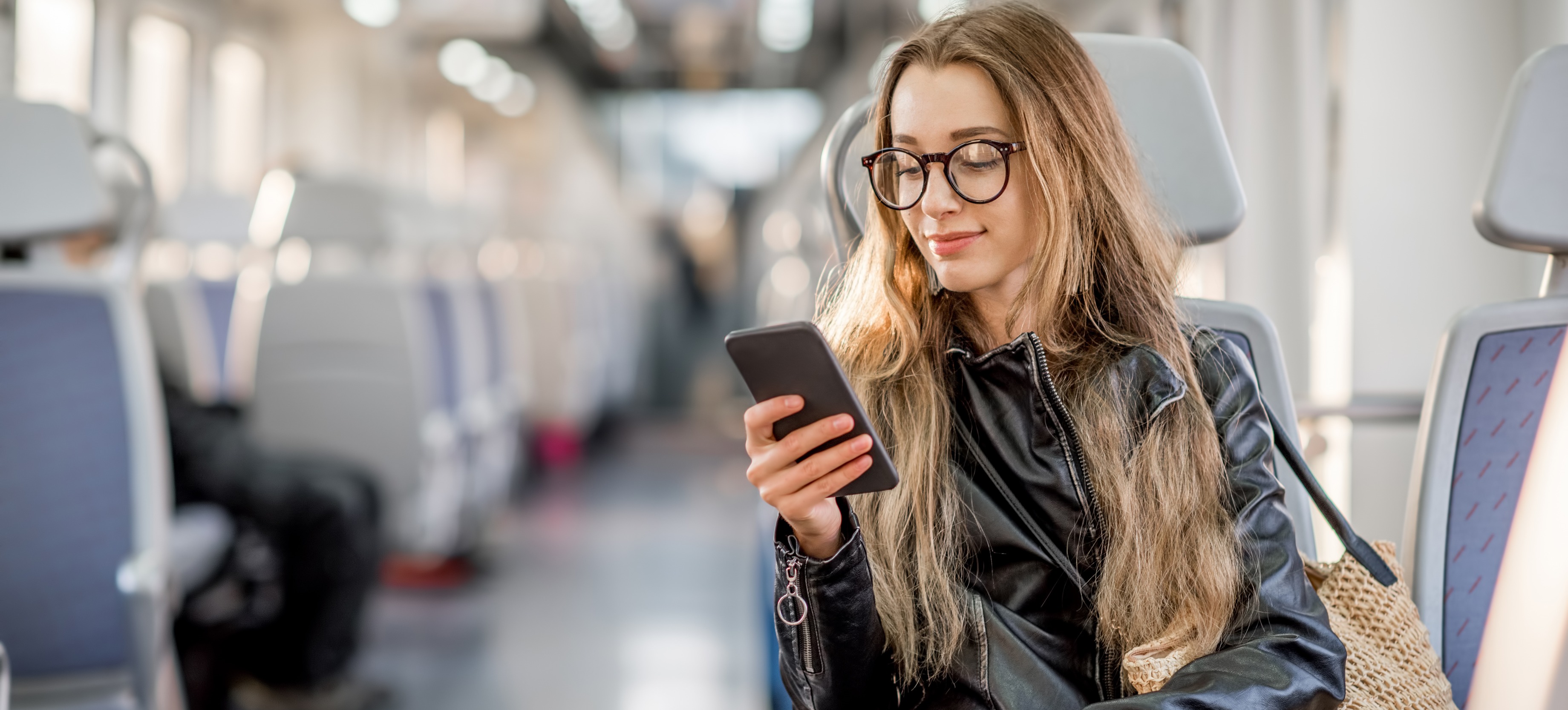 [Featured Image] A woman uses a smartphone to learn how to use LinkedIn while commuting on a bus.