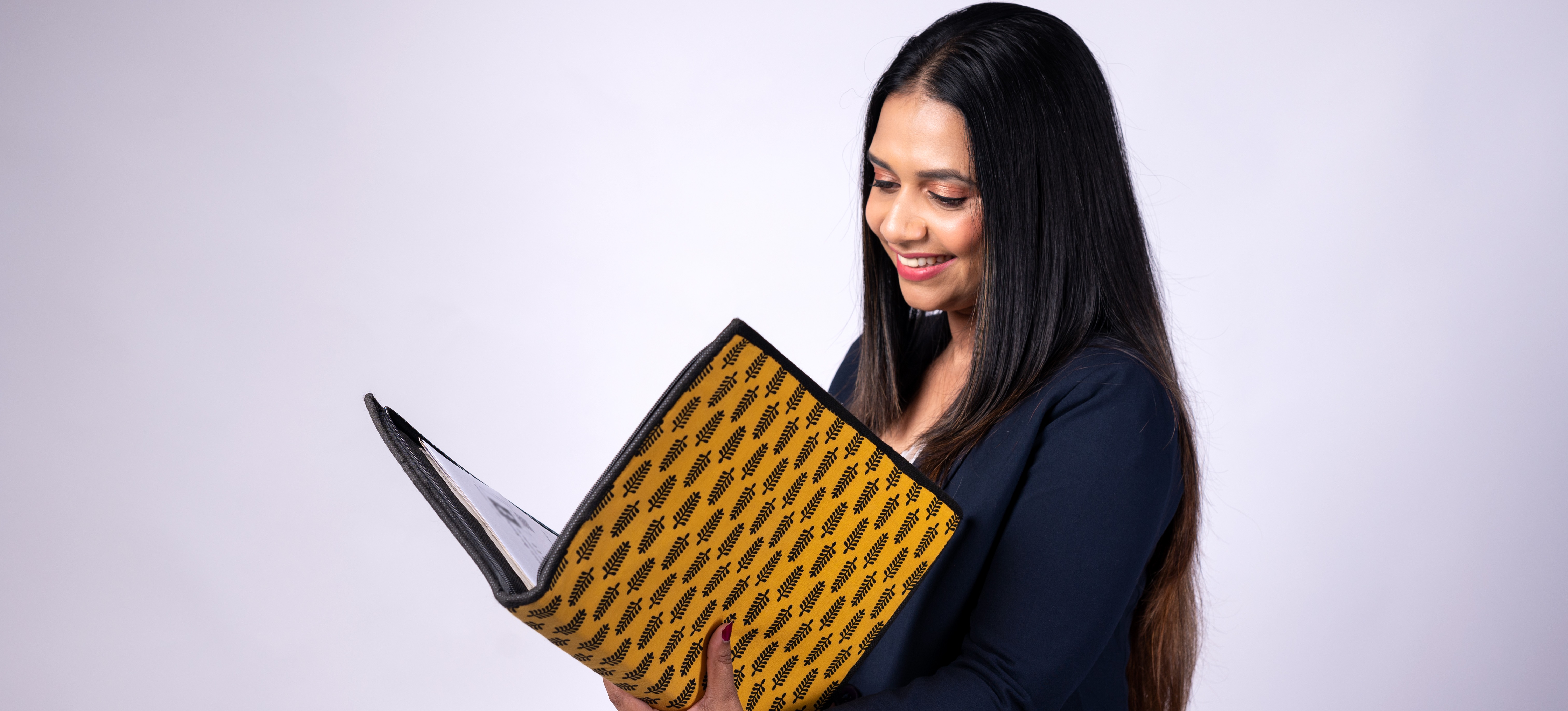 [Featured Image]: A professional reviews her resume to decide how many pages her resume should be as she prepares to apply for jobs.
