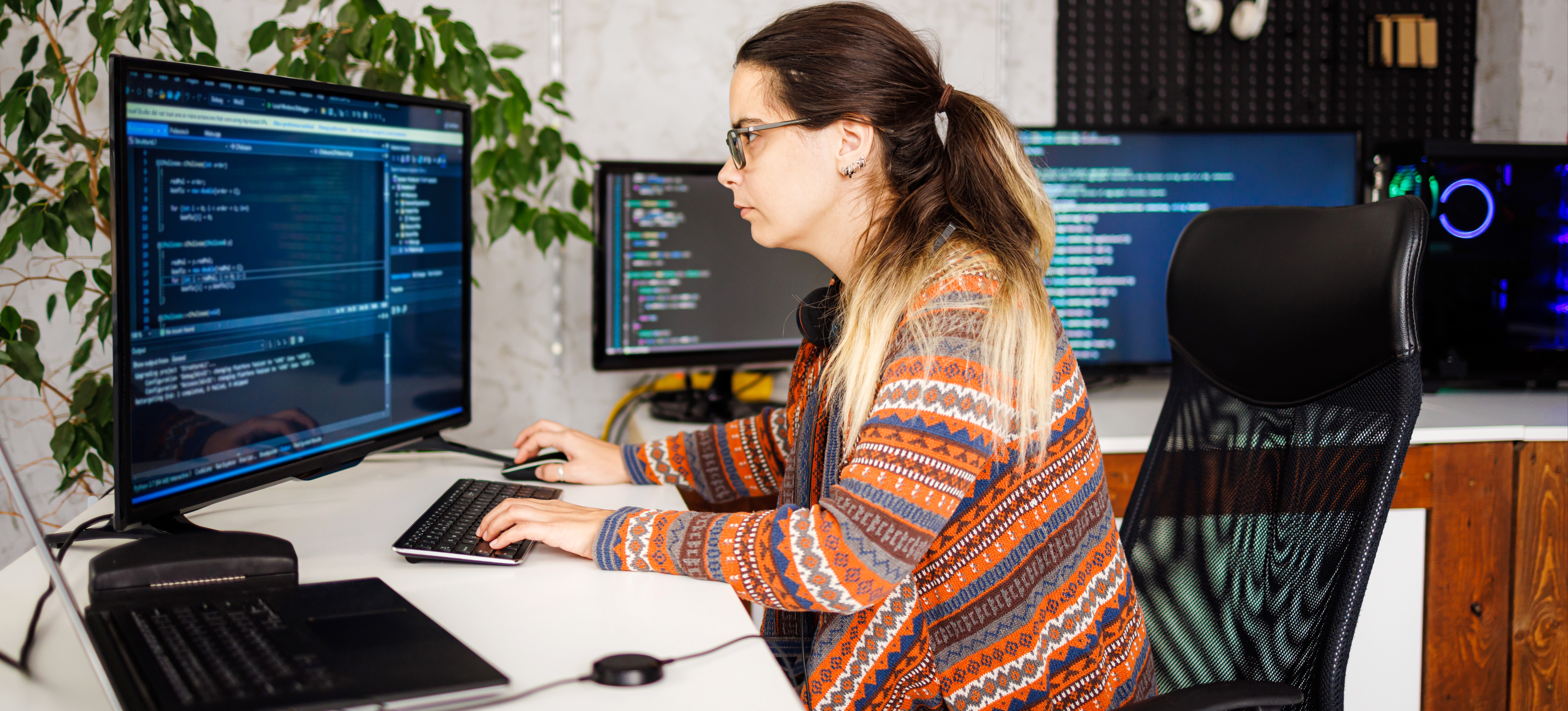 [Featured Image] A cybersecurity specialist in their workspace, working on a computer with web security-related tasks.

