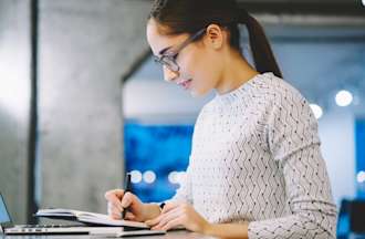 [Featured Image] An IT professional researches the best CompTIA certification path while on their laptop.