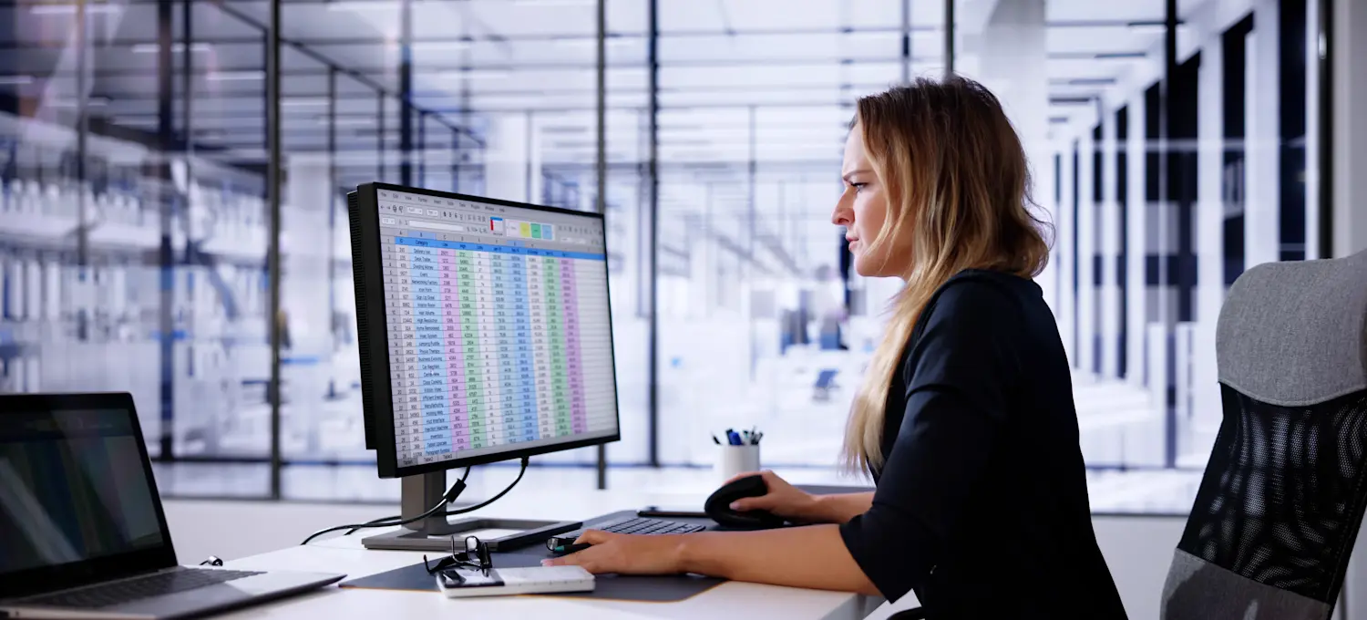 [Featured Image] A data analyst studies data organized by the REGEXMATCH function in Google Sheets while working on their computer in a well-lit office.