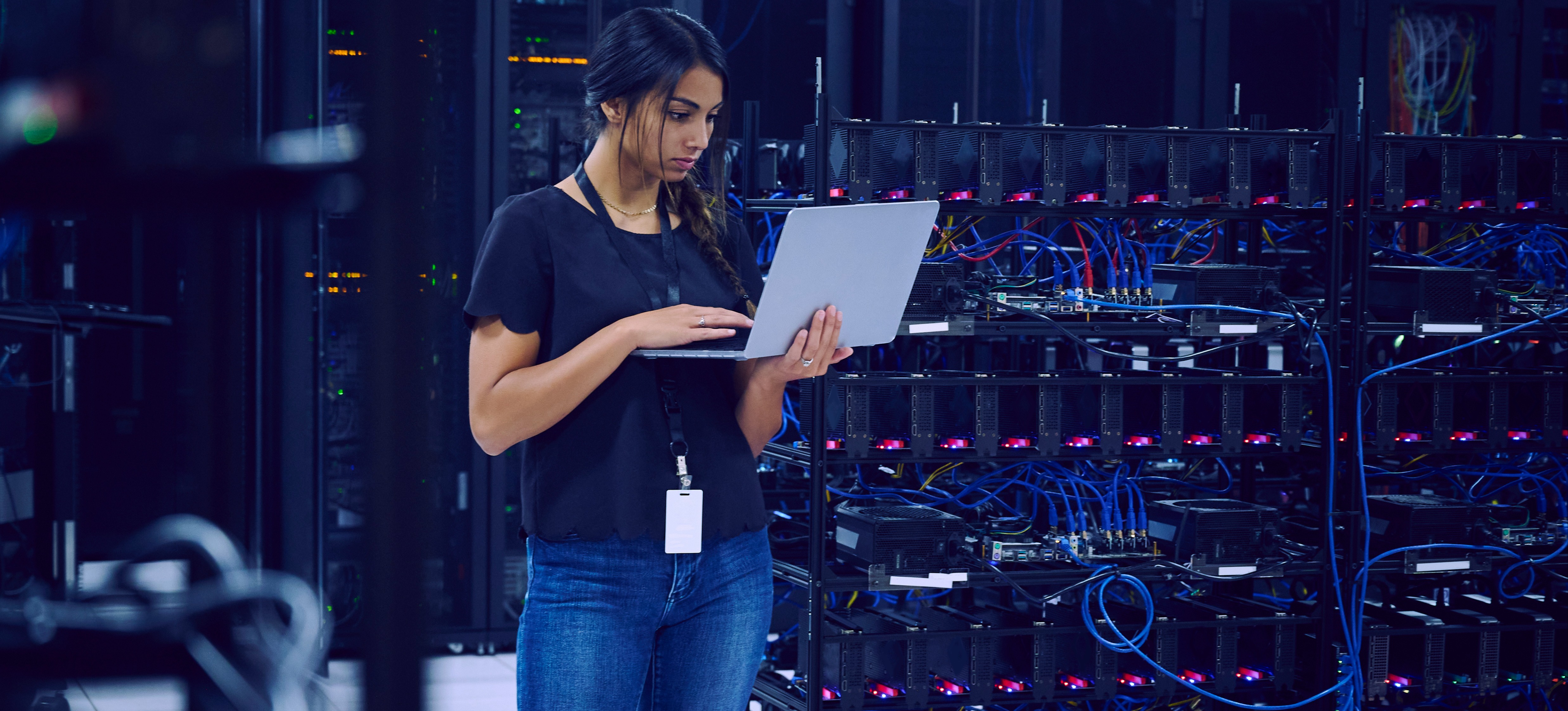 [Featured Image]: A technician standing in a server room secures data with advanced cryptography algorithms.
