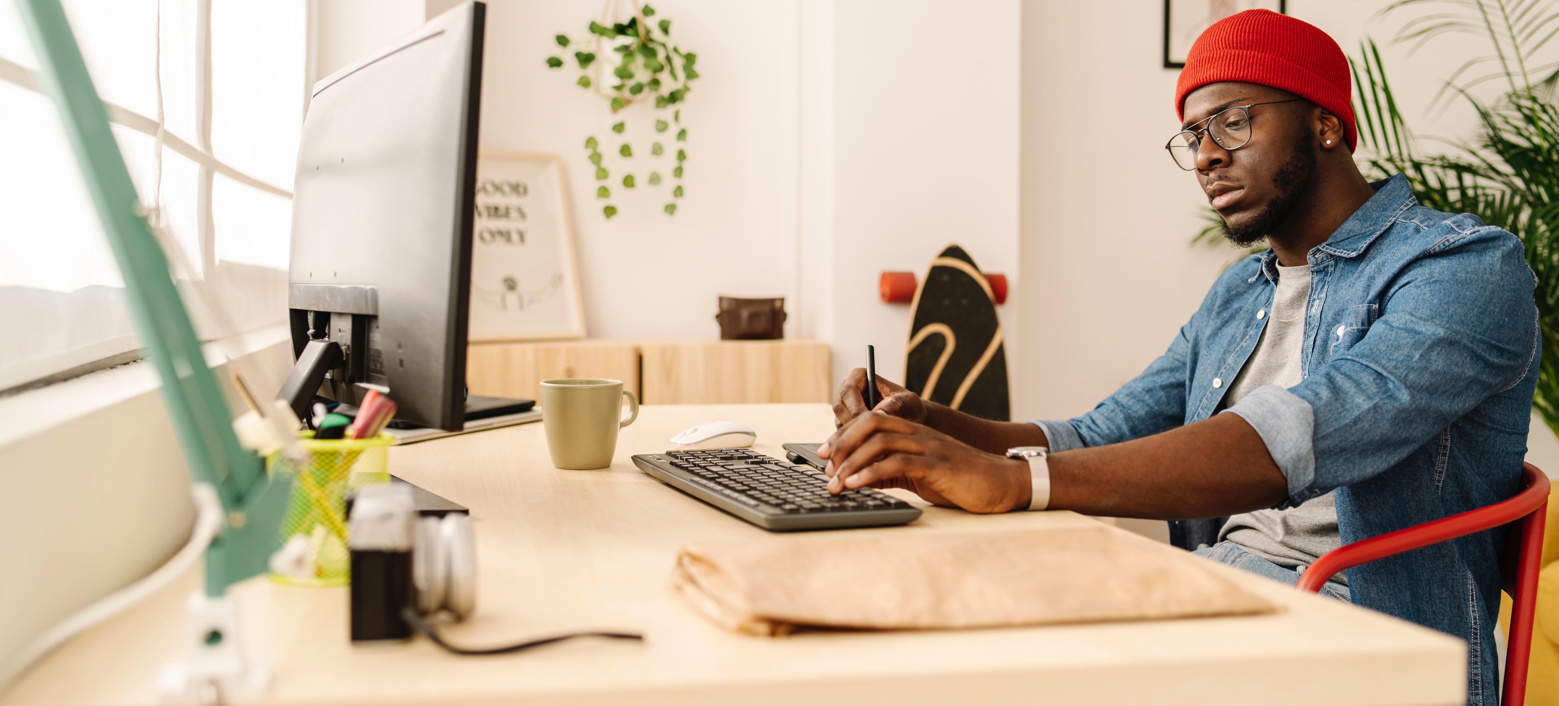 [Feature Image]: A graphic designer works to learn AI for graphic design on a desktop computer as they strive to upskill to advance their career. 
