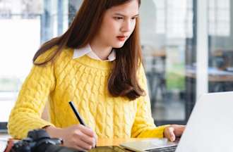 [Featured image] A UX designer is studying for her user interview on her laptop. 