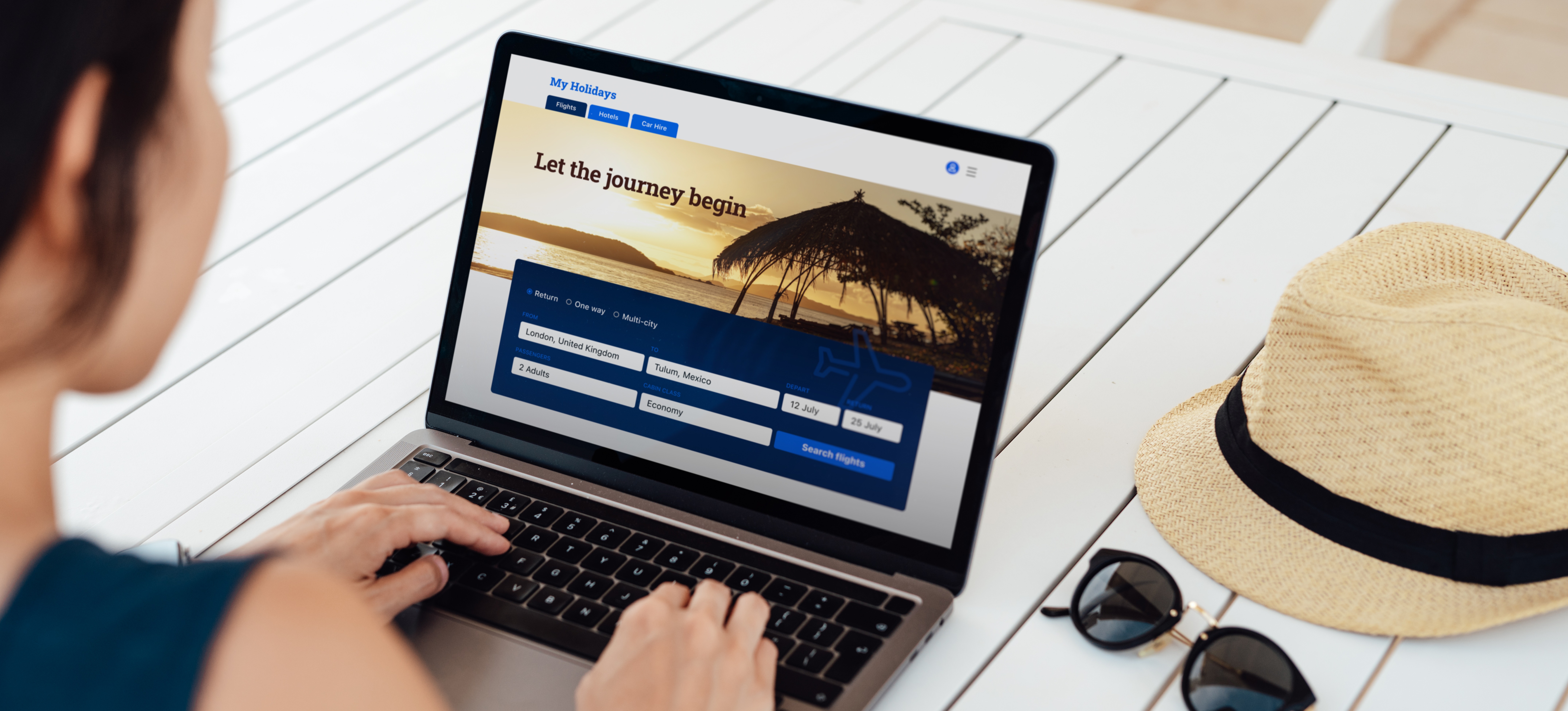 [Featured Image] A person sits at a laptop and books a trip with a travel website that uses data aggregation to pull flight and lodging data from numerous sources. 
