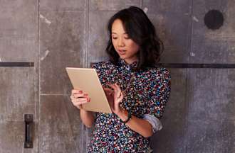 [Featured Image] A woman works on a tablet.